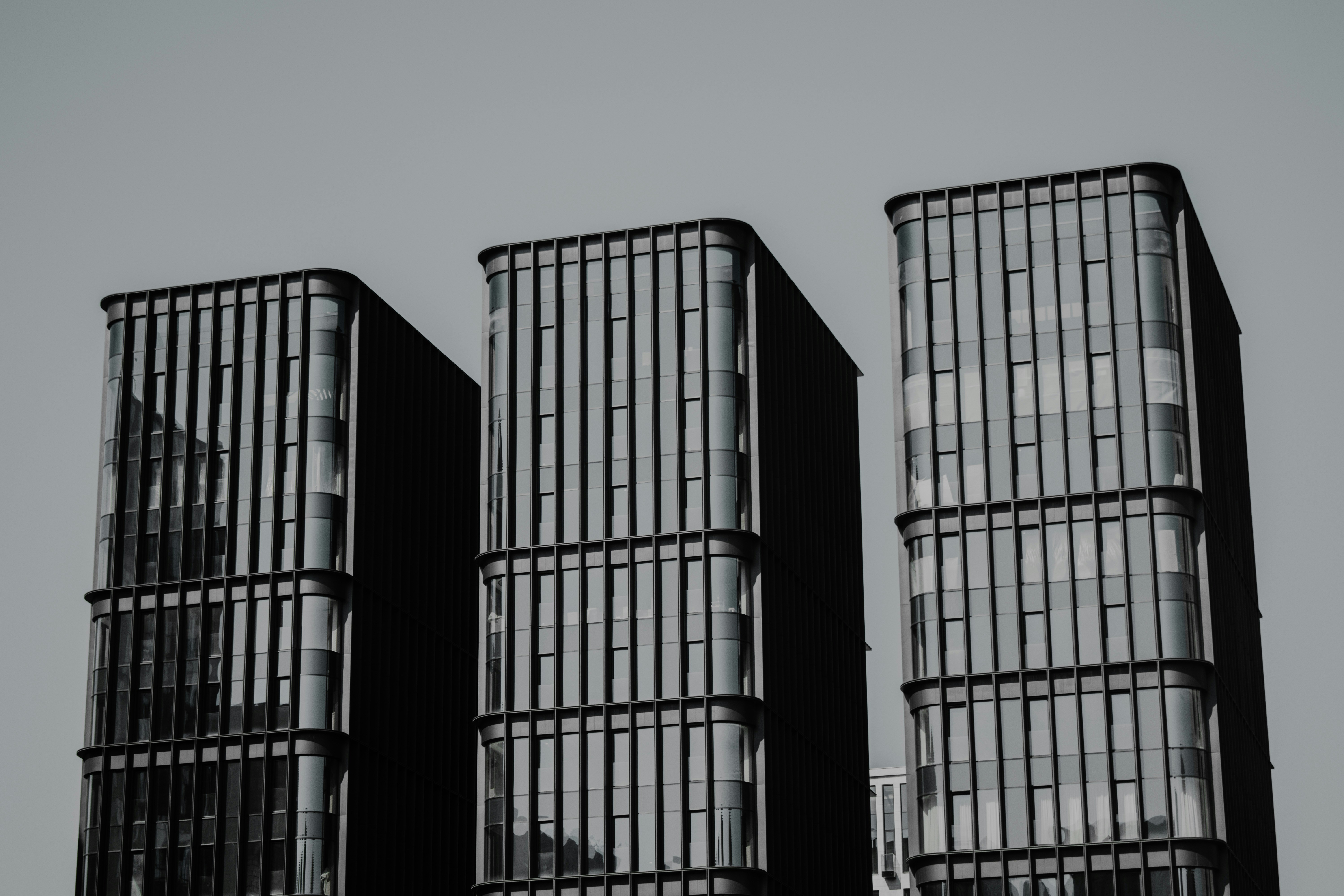 a black and white photo of three tall buildings