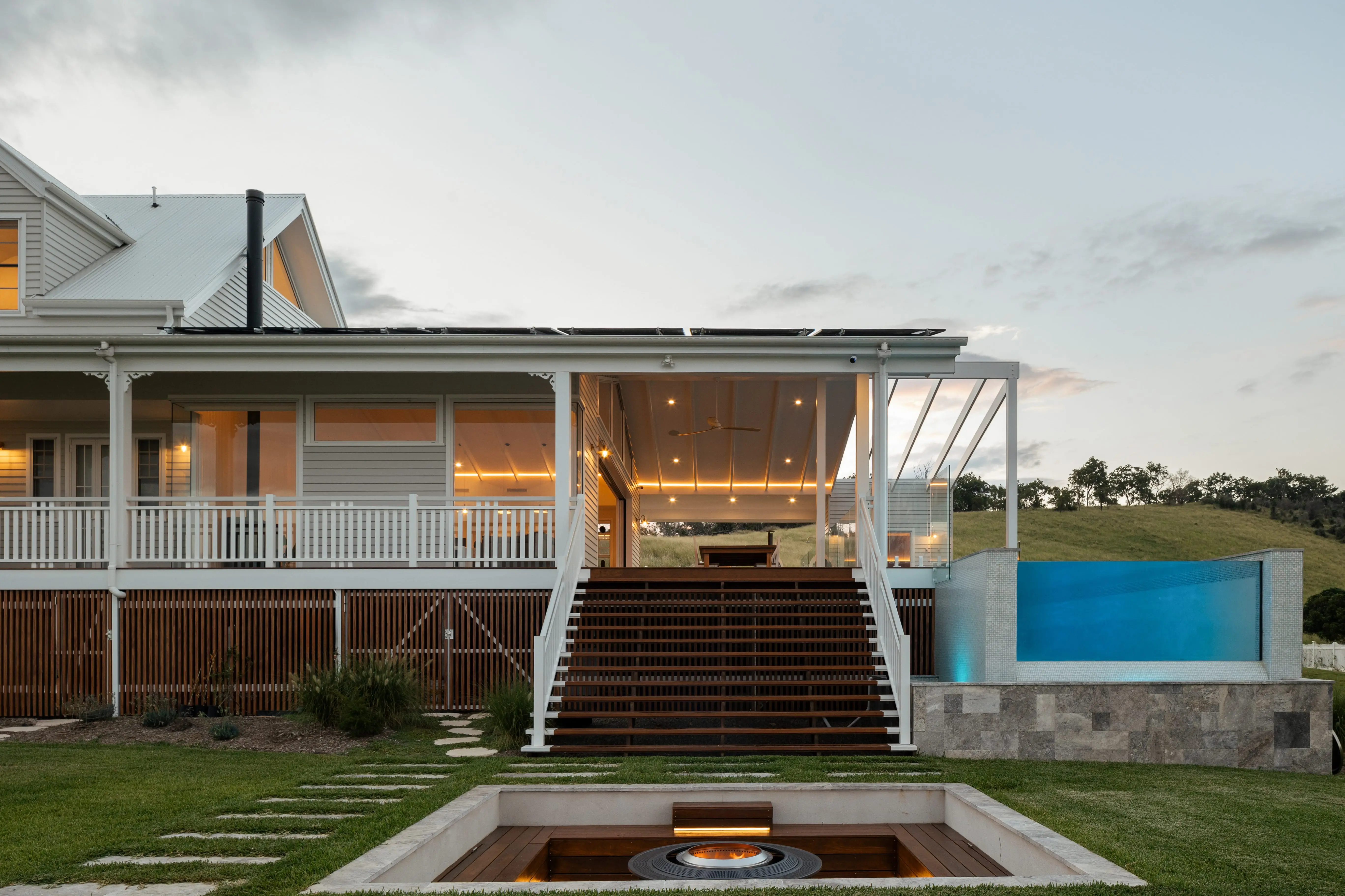 A view of the firepit, stairs to the outside entertainment area and pool at Illalangi designed by Invilla Architecture