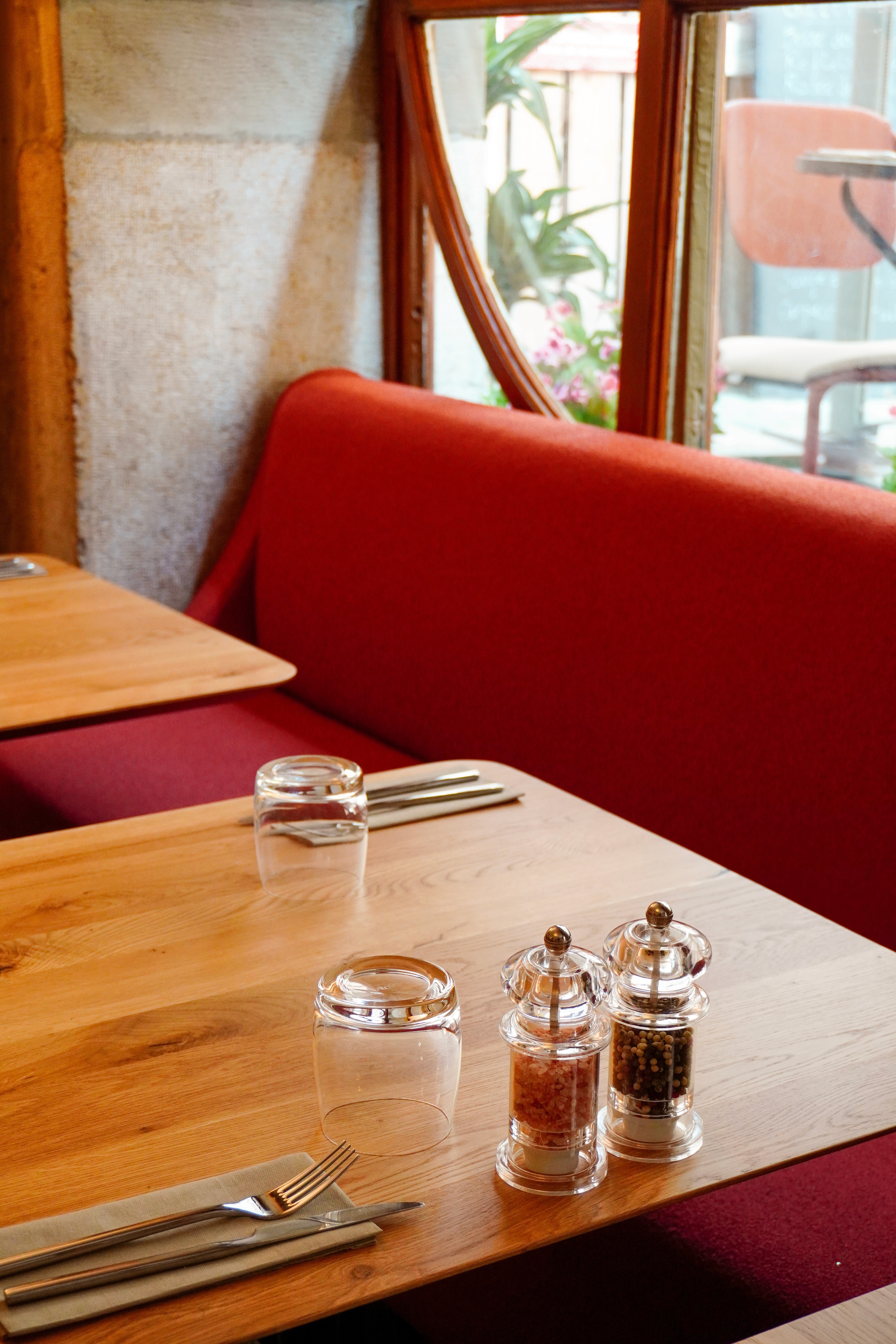a glass of cocktail with a slime orange fruit