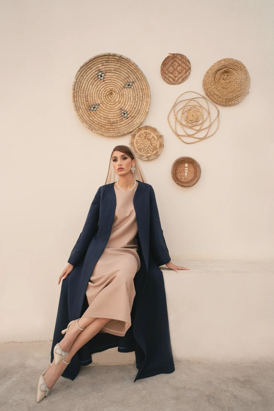 Navy coat over a sand dress