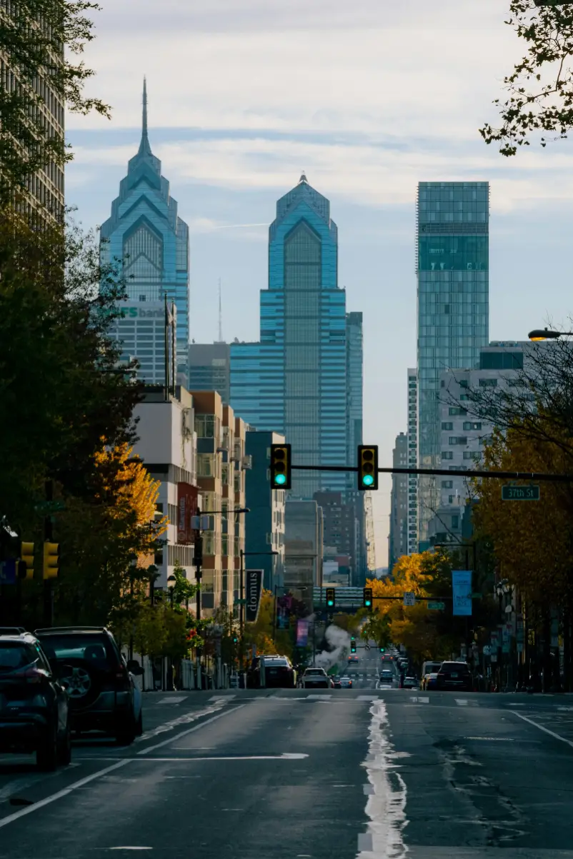 a traffic light on a city street with tall buildings in the background