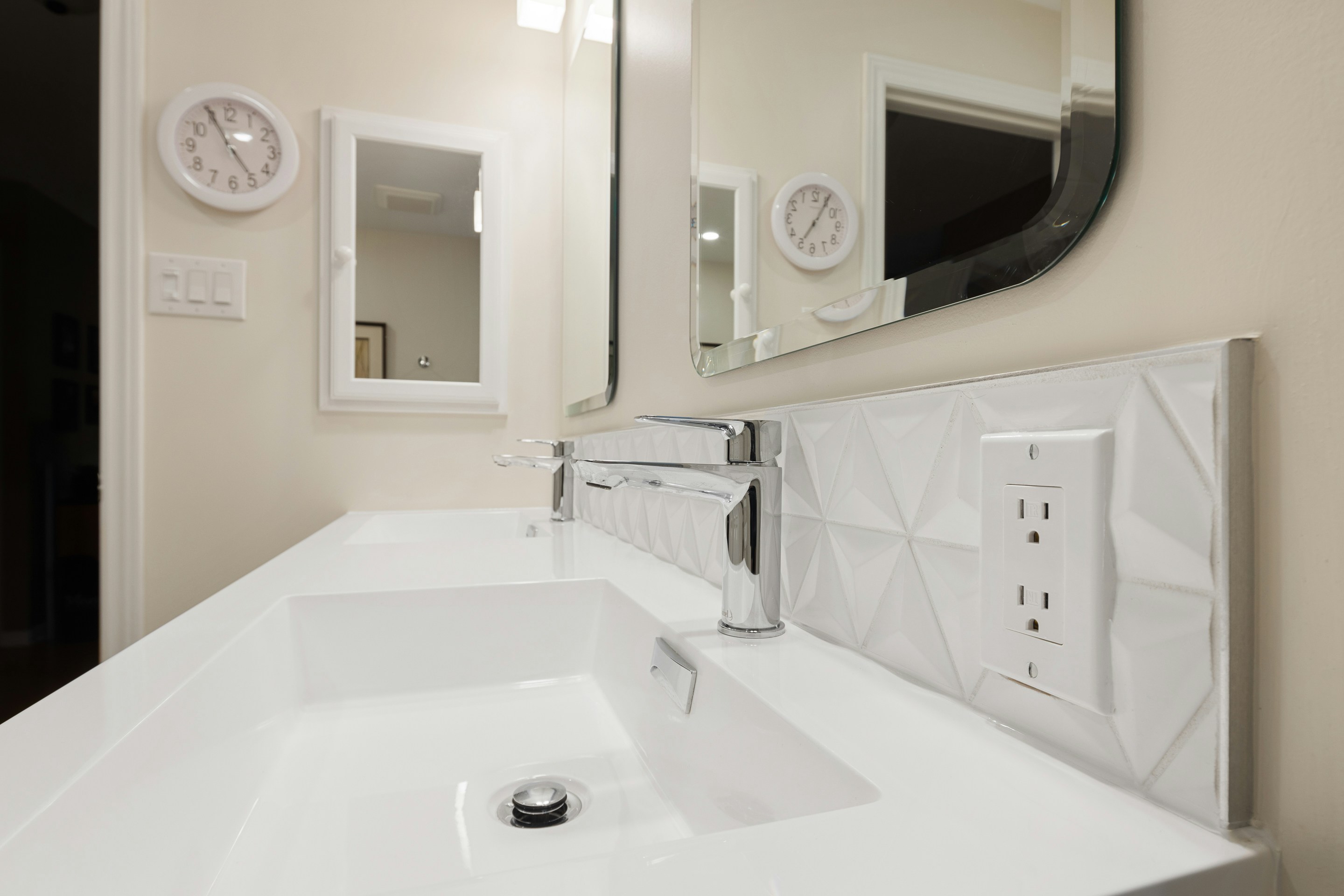 a bathroom with a sink and mirrors