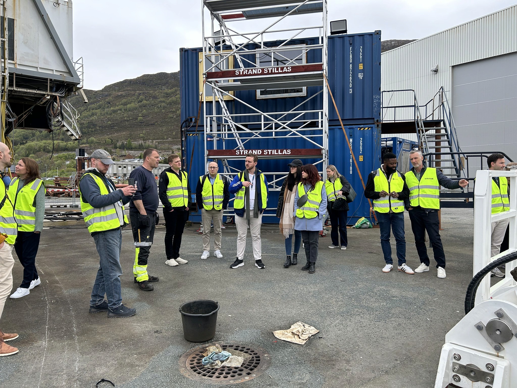 Four business professionals engaging in a handshake during a meeting at a modern office setting.