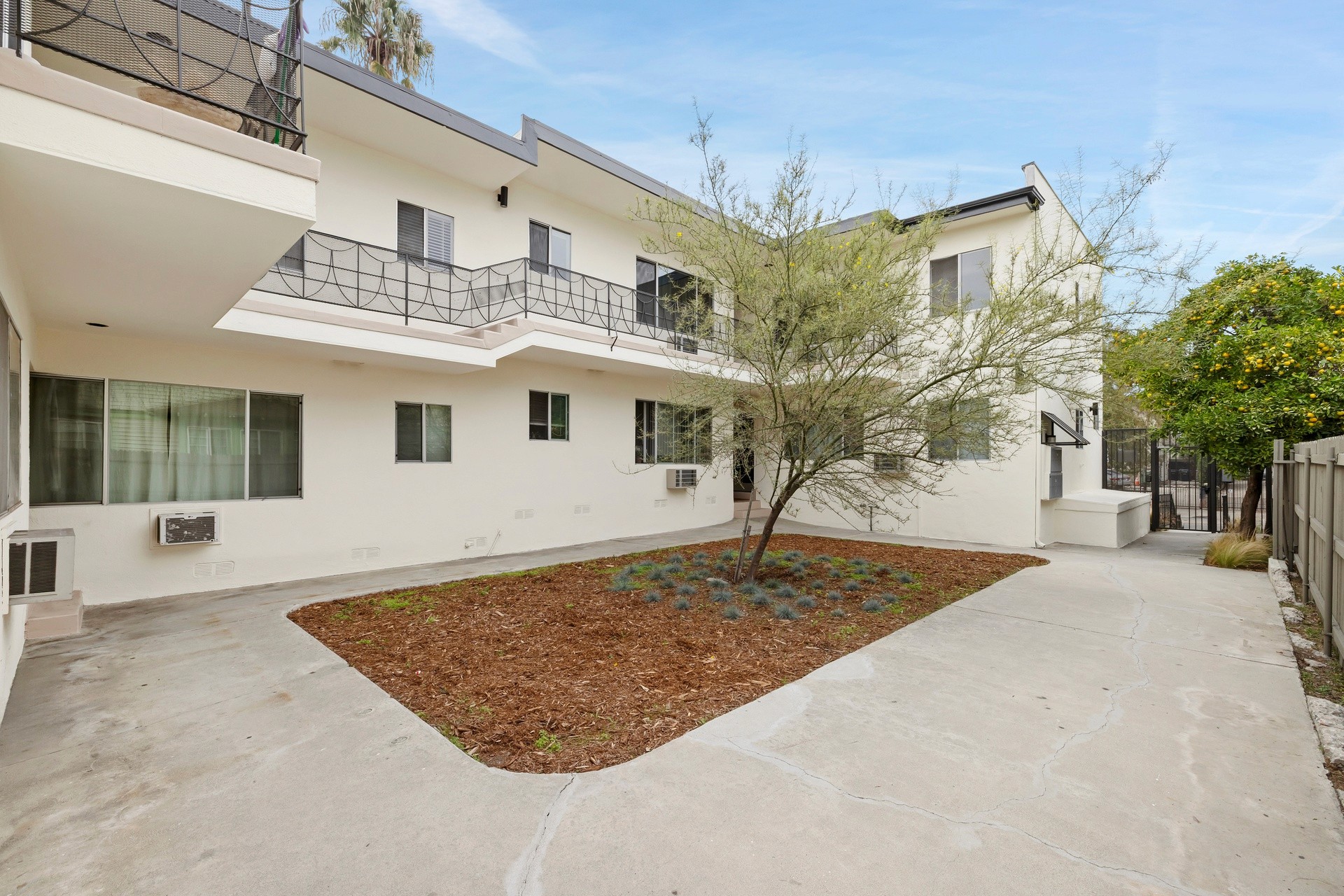 200 N Rampart landscaped interior courtyard with new plantings, open walkways and updated exterior.