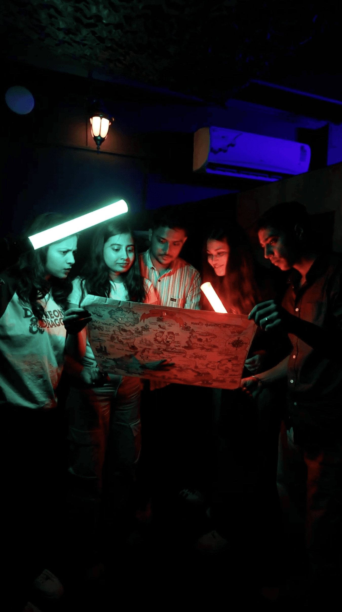 Group of friends or teammates solving puzzle together inside mystery escape games