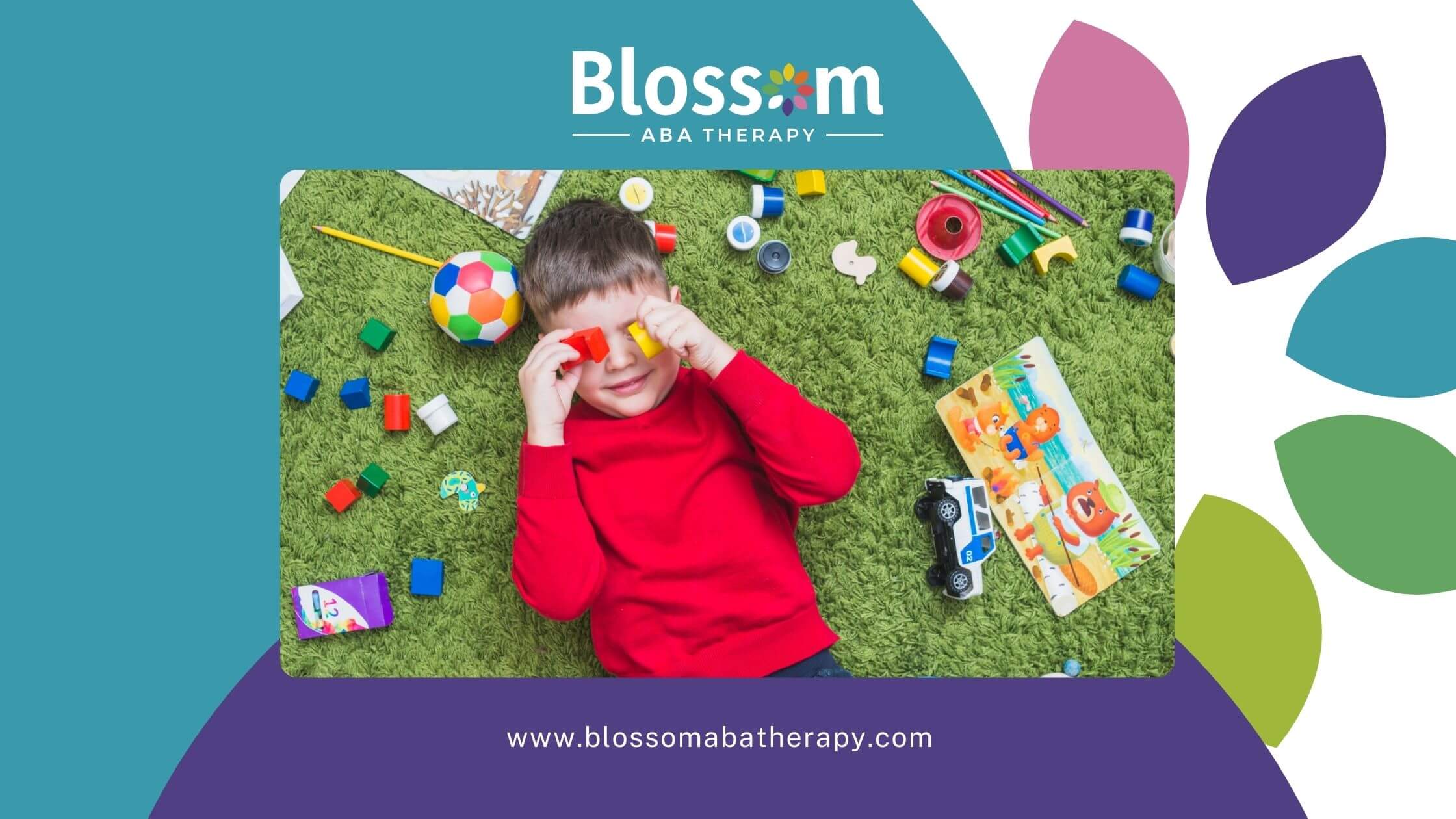 A young boy with autism playing on the floor with colorful toys and building blocks during ABA therapy activity.