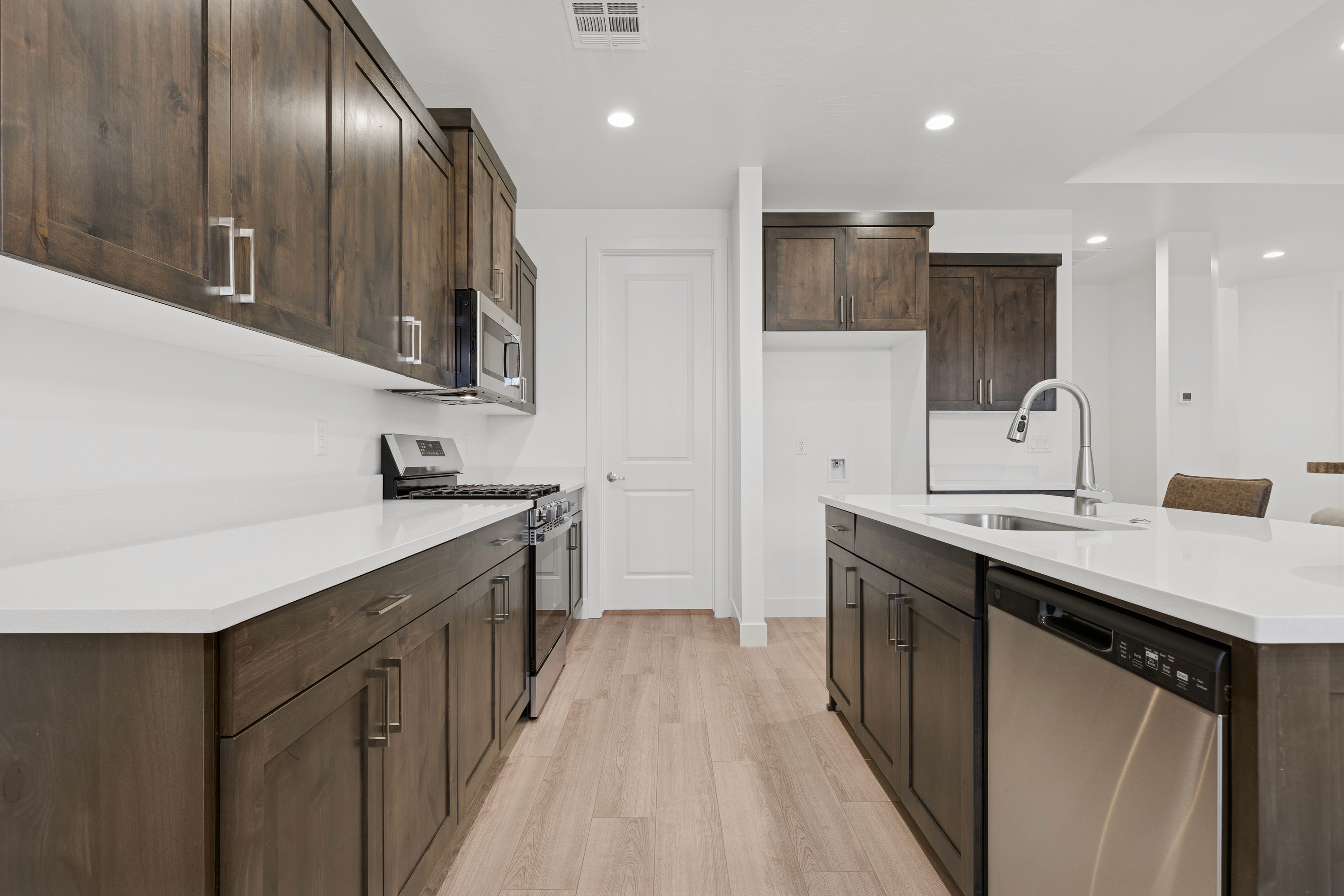 Contemporary kitchen with island and sleek finishes in The High Desert Home in Hurricane Utah.