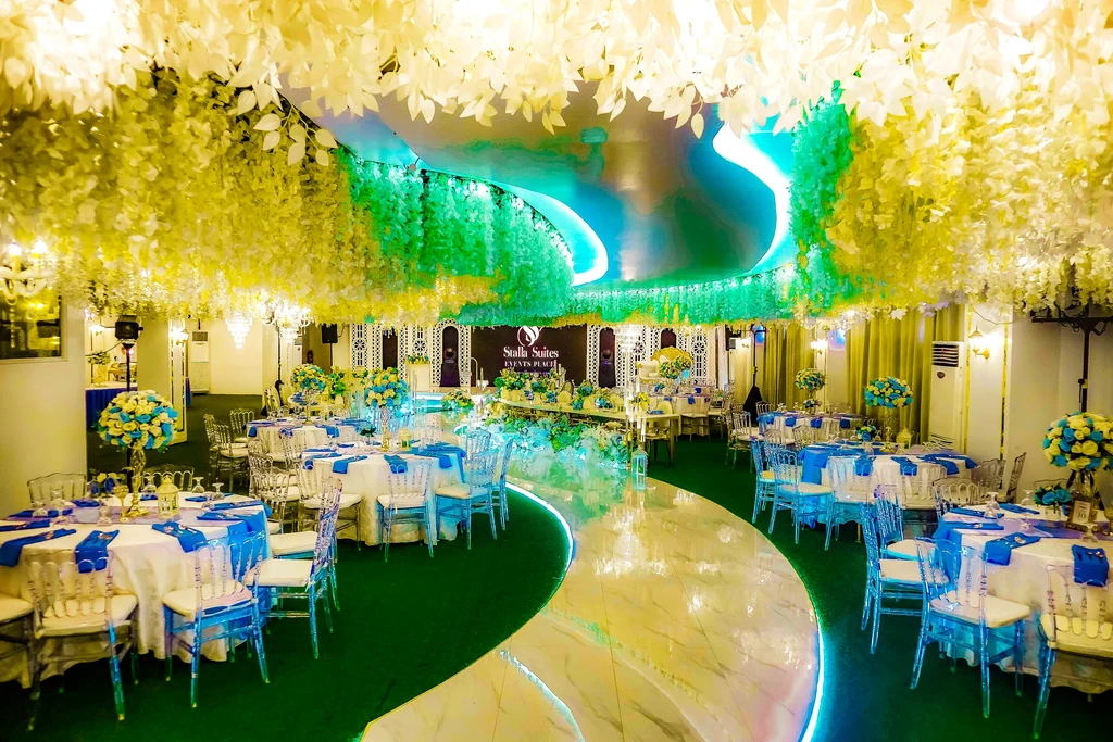 Reception tables in white and blue along the marble aisle of Celestia Hall