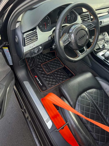 a man is working on an orange car