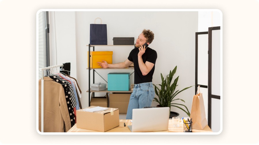 Entrepreneur working in a modern space with boxes and clothing