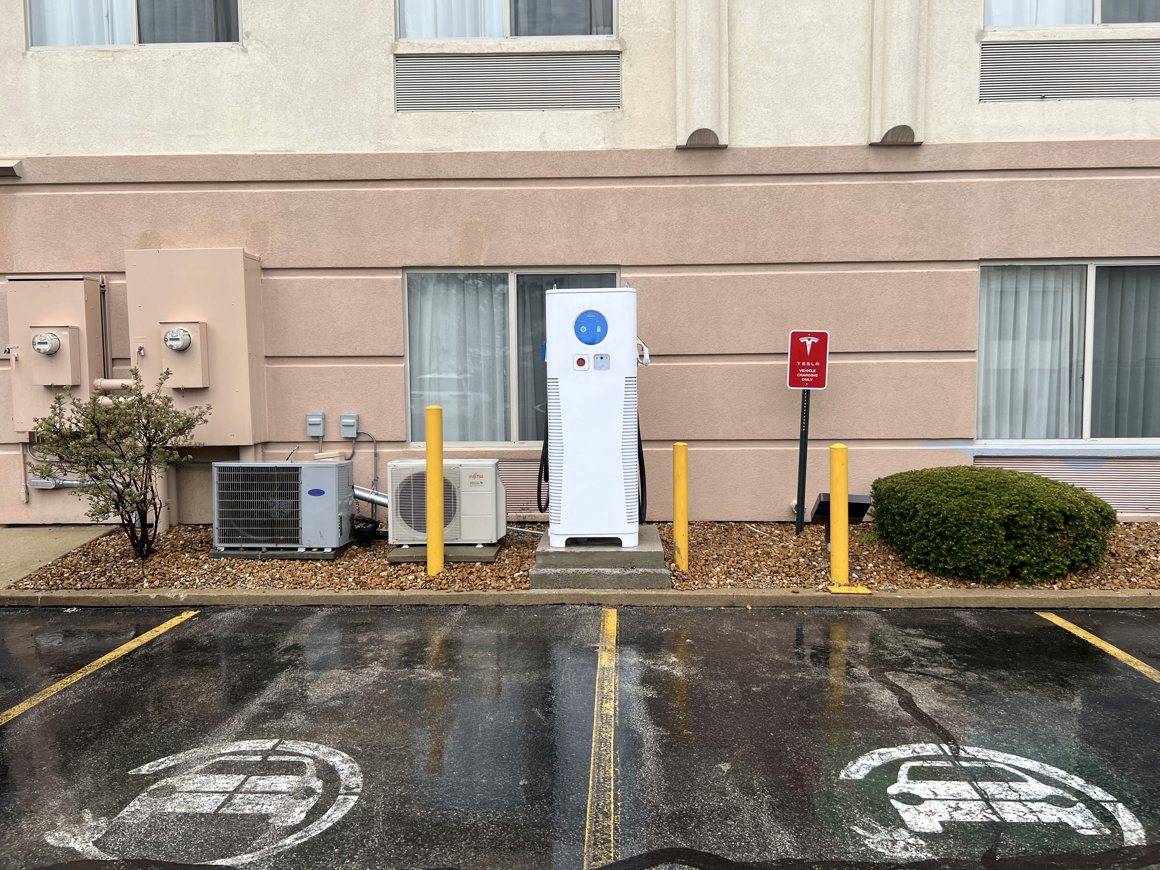 C6AM Charger in front of a pink hotel building