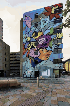 Man crouching next to a bicycle wheel.
