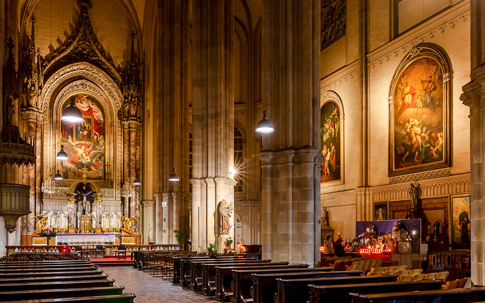 Interior of Minoritenkirche with ornate altar and classical paintings, Vienna concert venue.