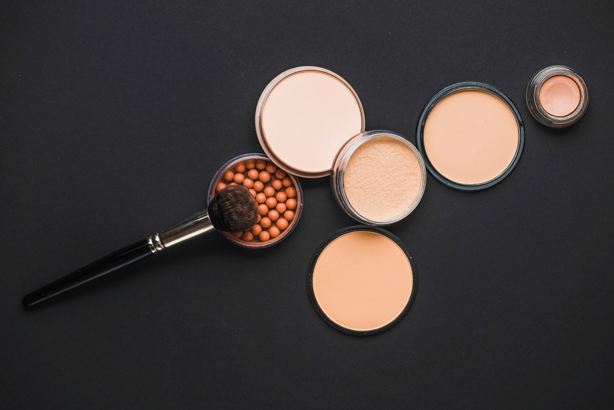 makeup powder with blush and a brush