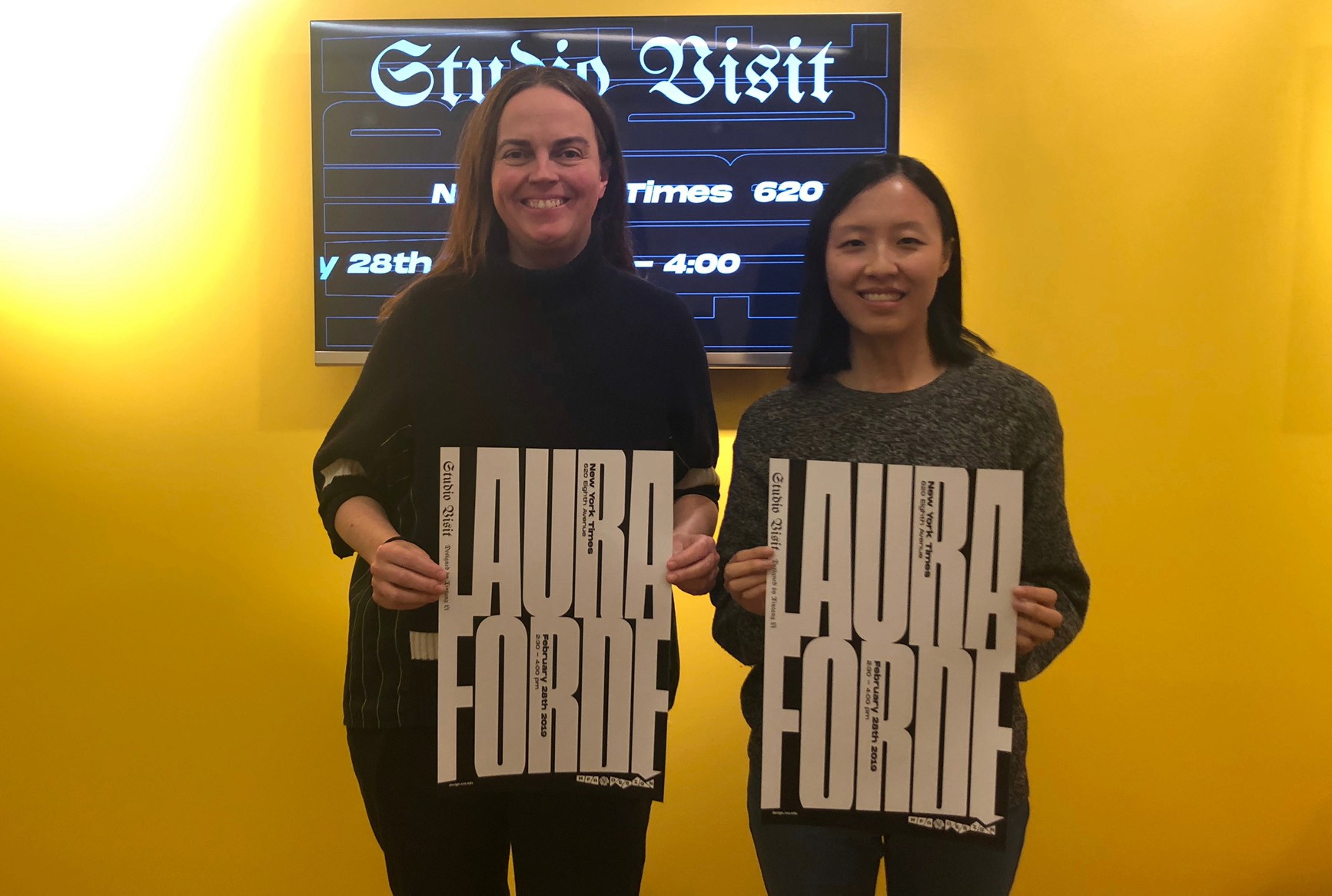 Laura Forde with a student holding posters