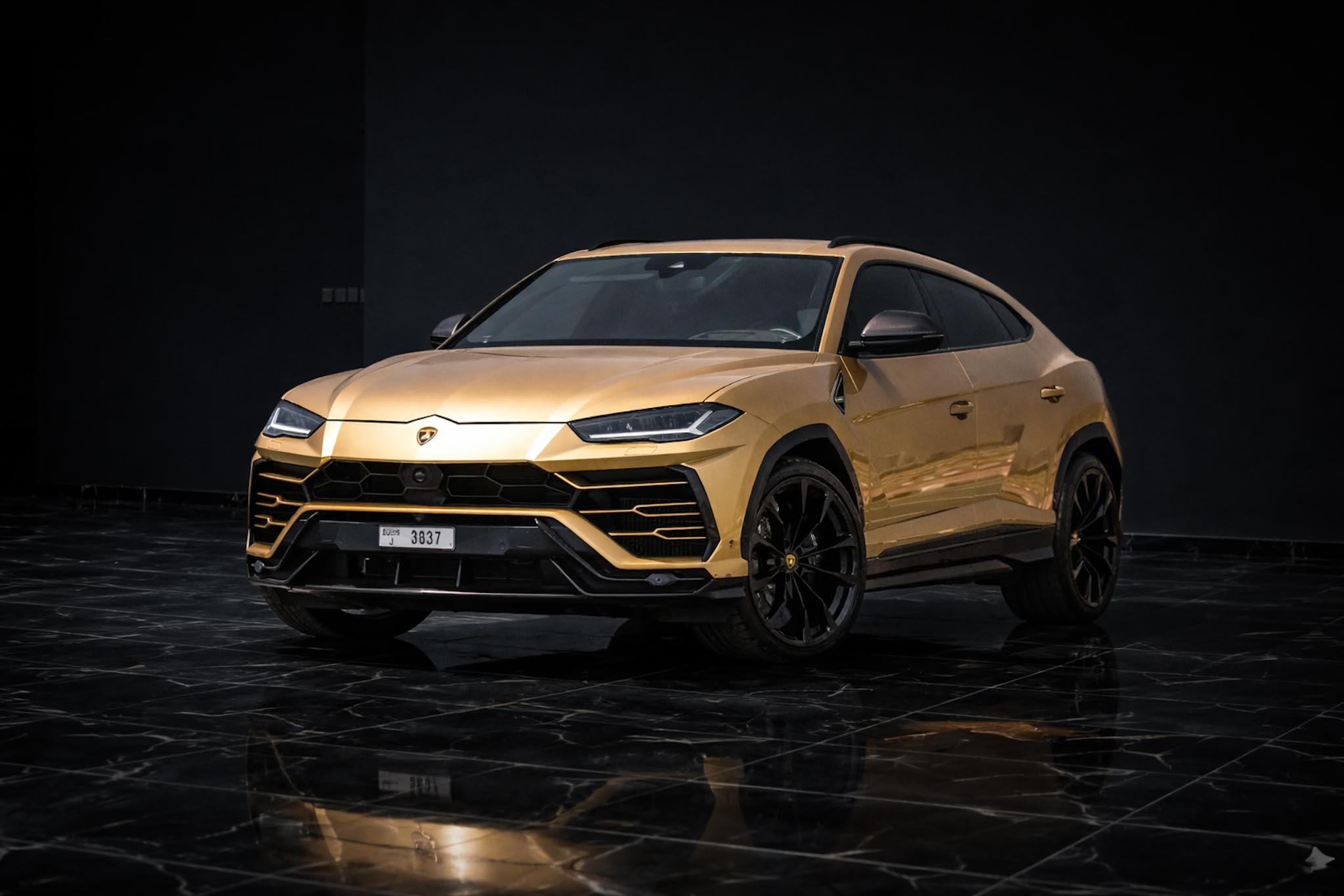 Gold Lamborghini Urus luxury SUV front view Dubai supercar rental