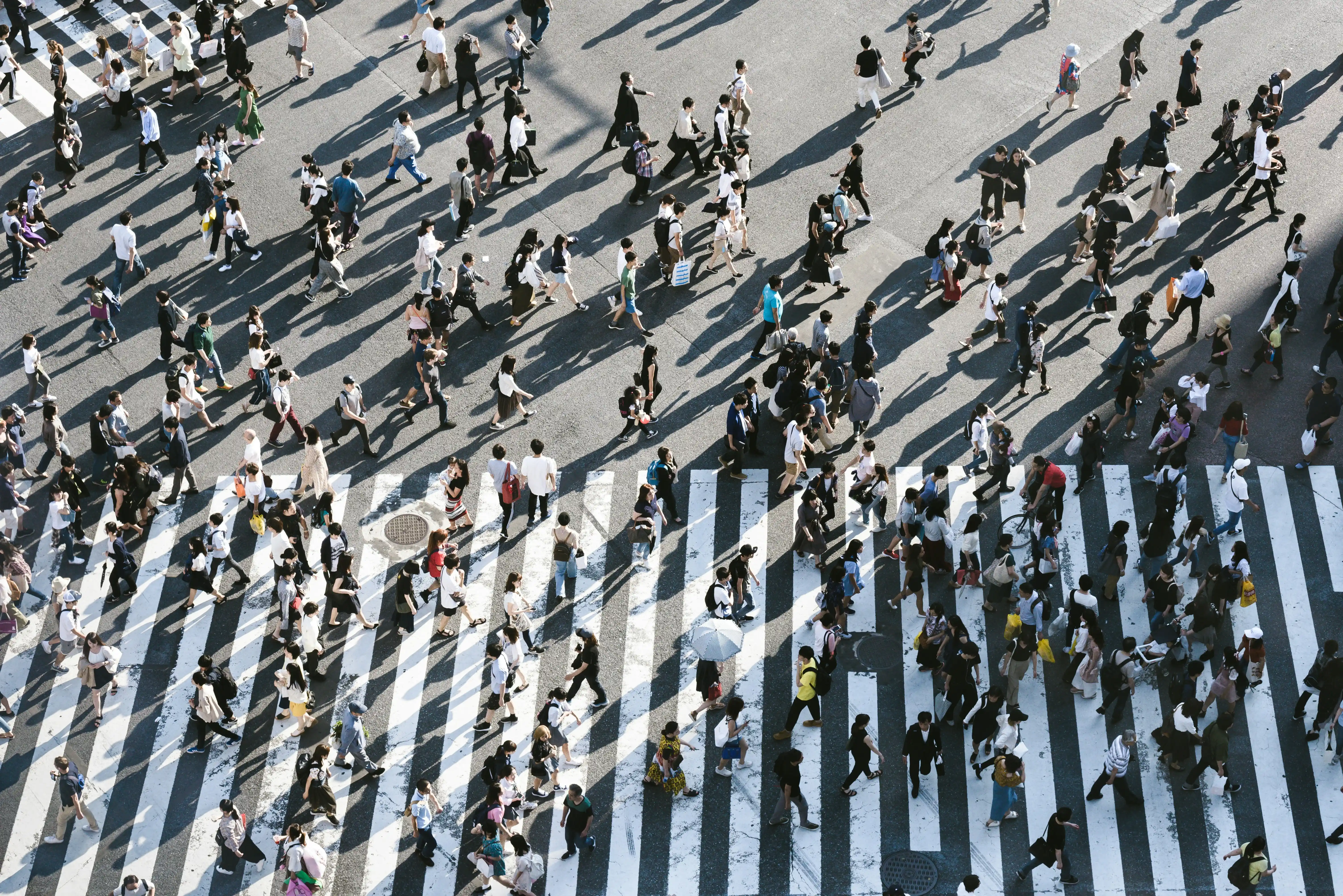 Crowded downtown sidewalk with pedestrians rushing to work.