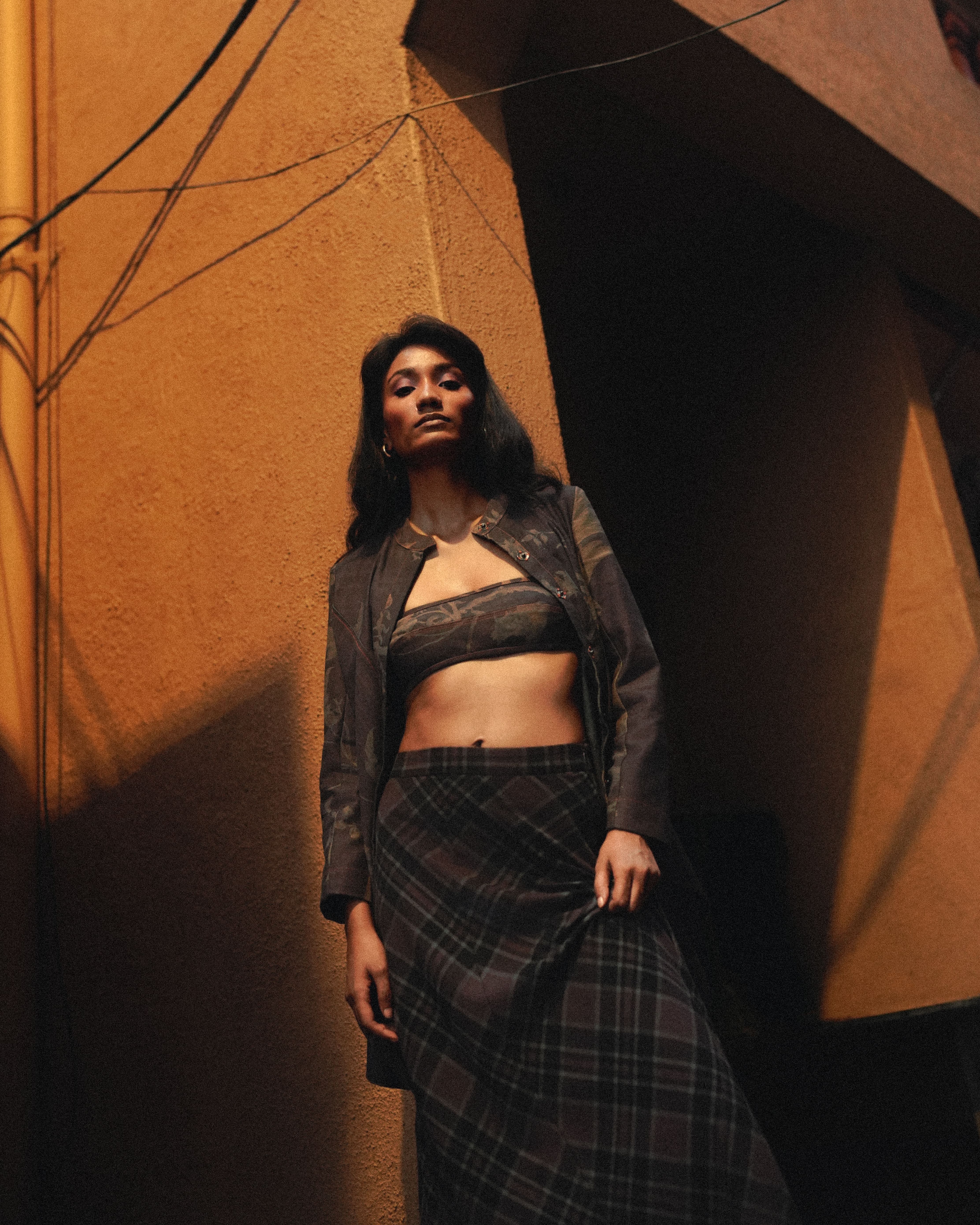 Person sitting on a ledge overlooking New York City skyline