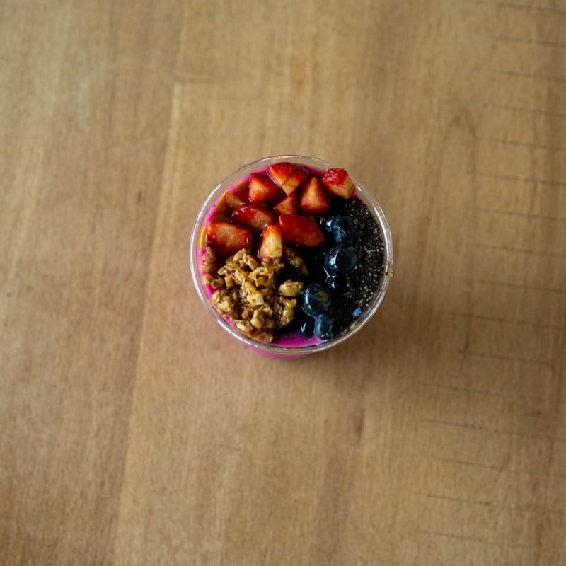 A beautifully arranged table with various dishes, including fruits, bread, and wine, set for a meal.