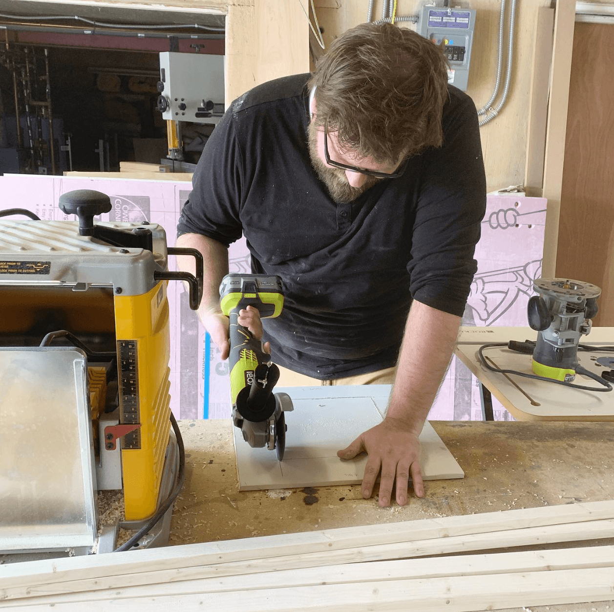 Brian using an angel grinder to cut drywall. Don't ask why.