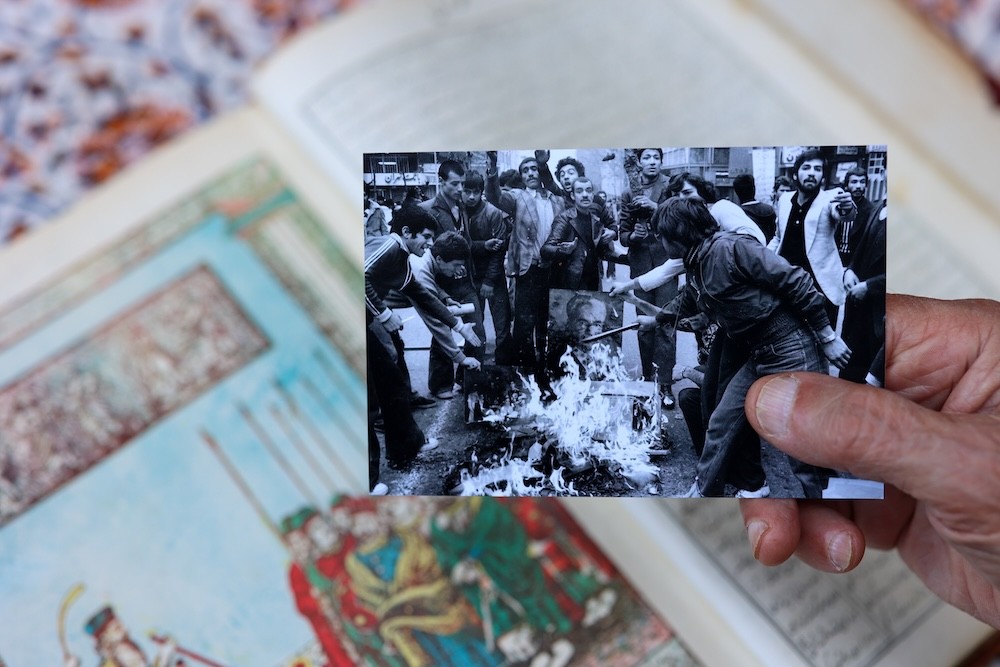 Bubjan with book and speaking to camera