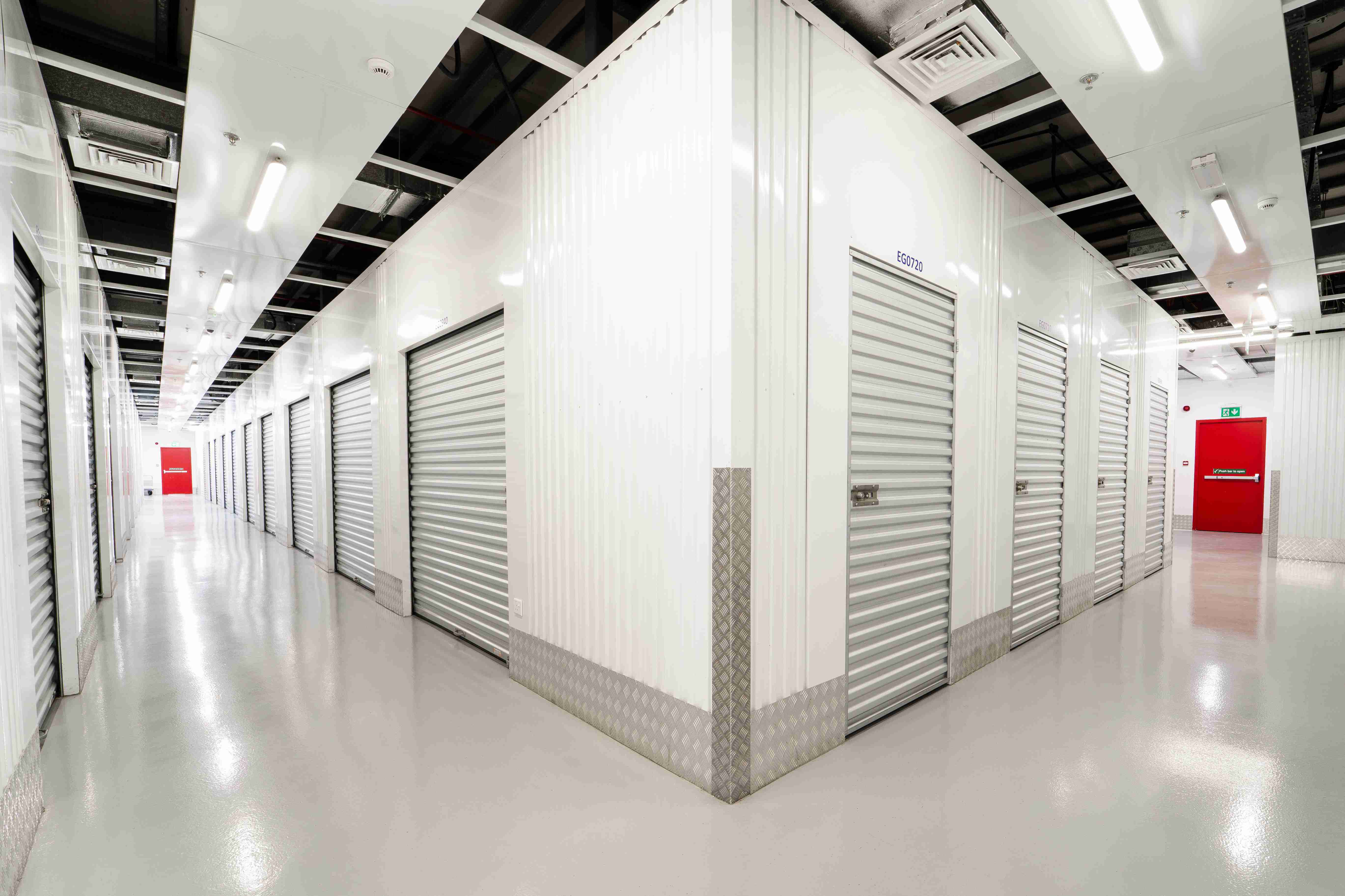Bright hallway with roll-up doors and polished floors in a secure storage facility Dubai.