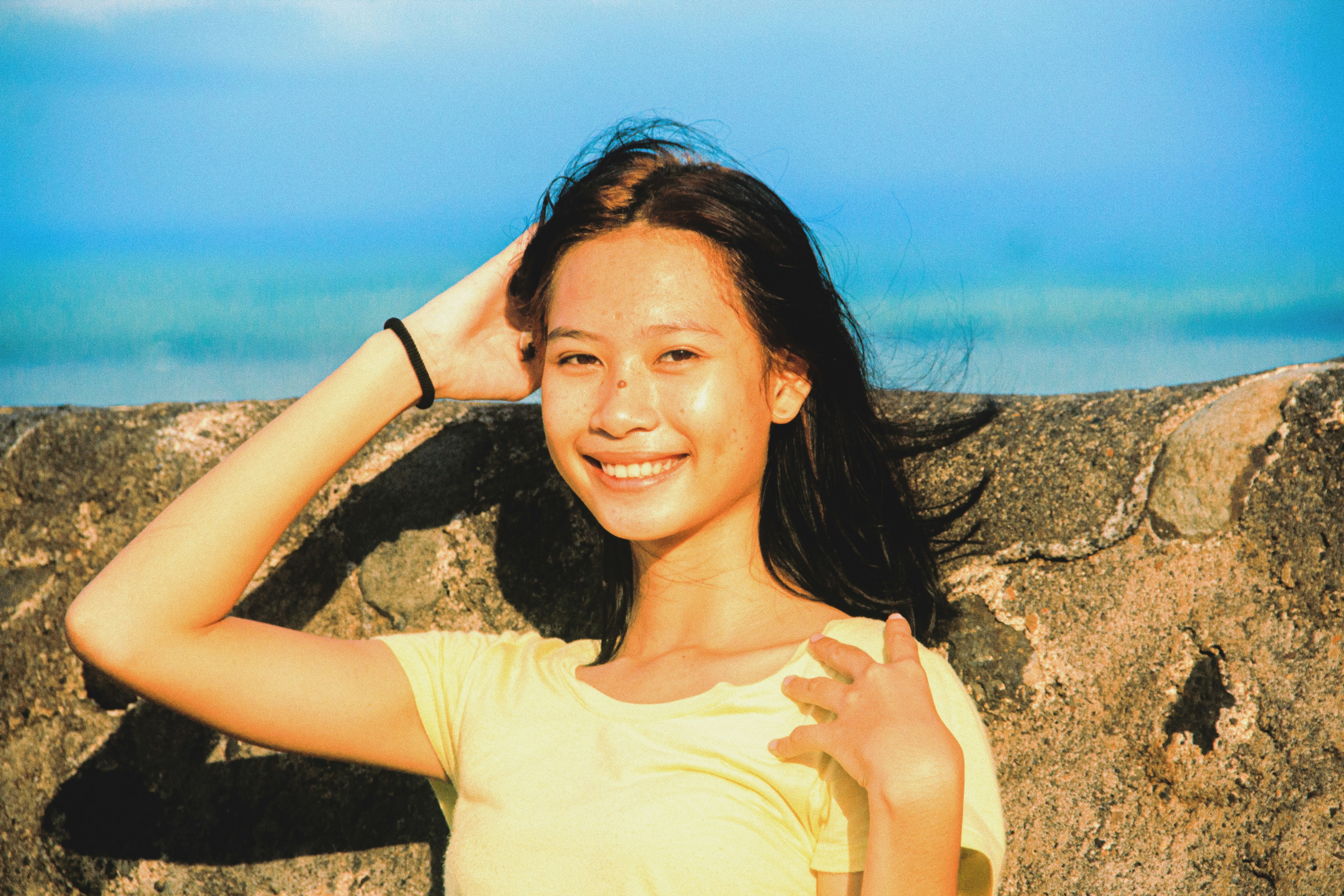 woman in white tank top smiling