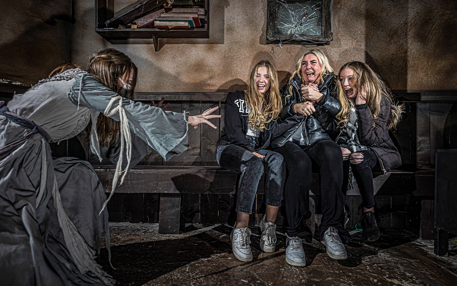 Visitors react to a costumed actor at the London Dungeon VIP experience.