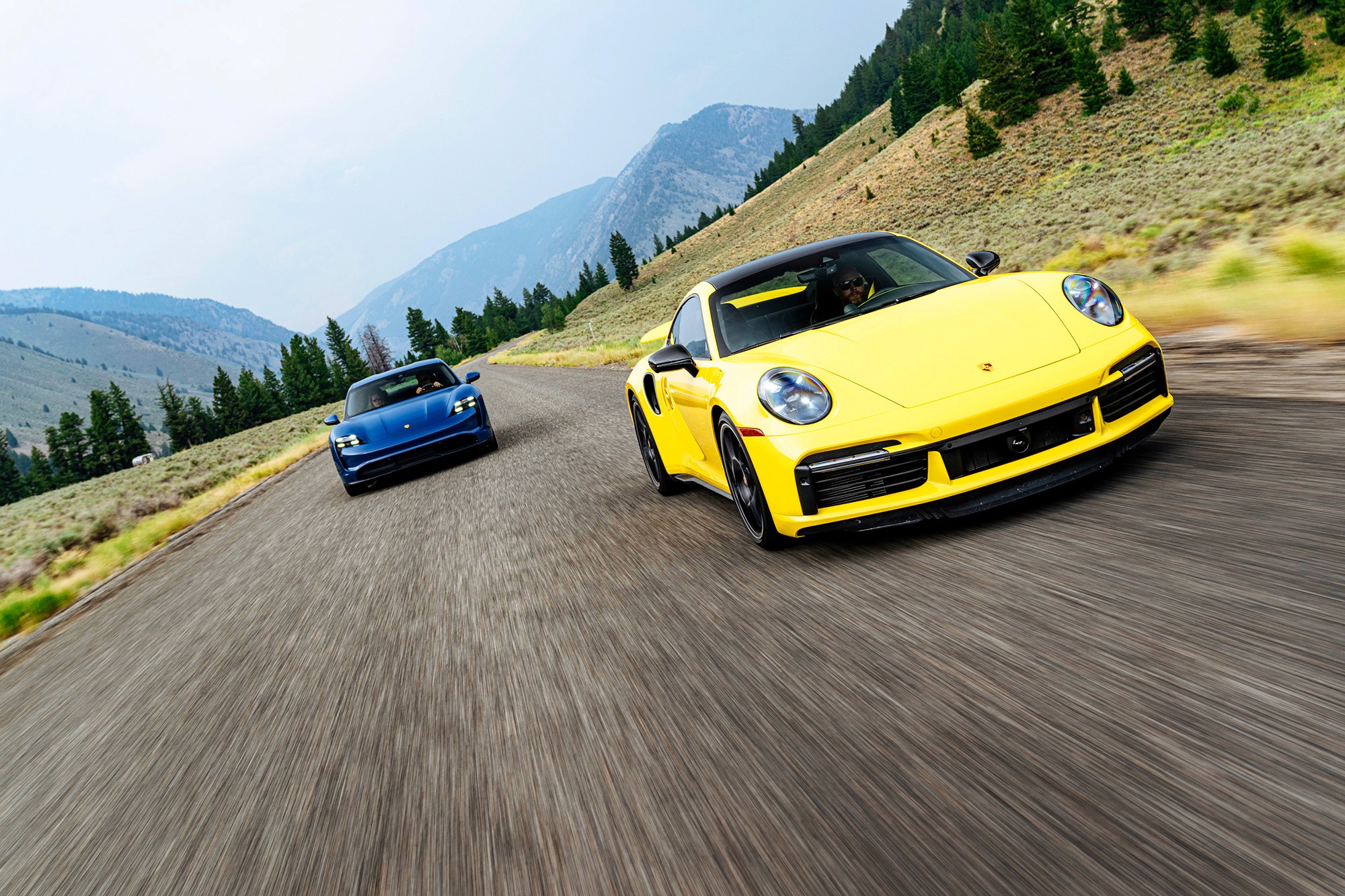 Two porsches driving side by side