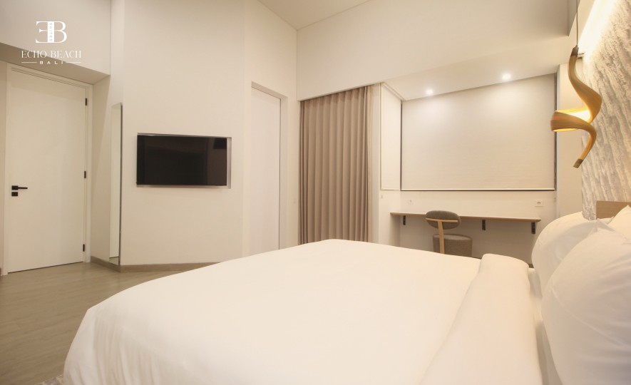 Bright living room and dining area of the Echo Beach Suite apartment in Canggu, Bali, ideal for a comfortable stay with three bathroom access.