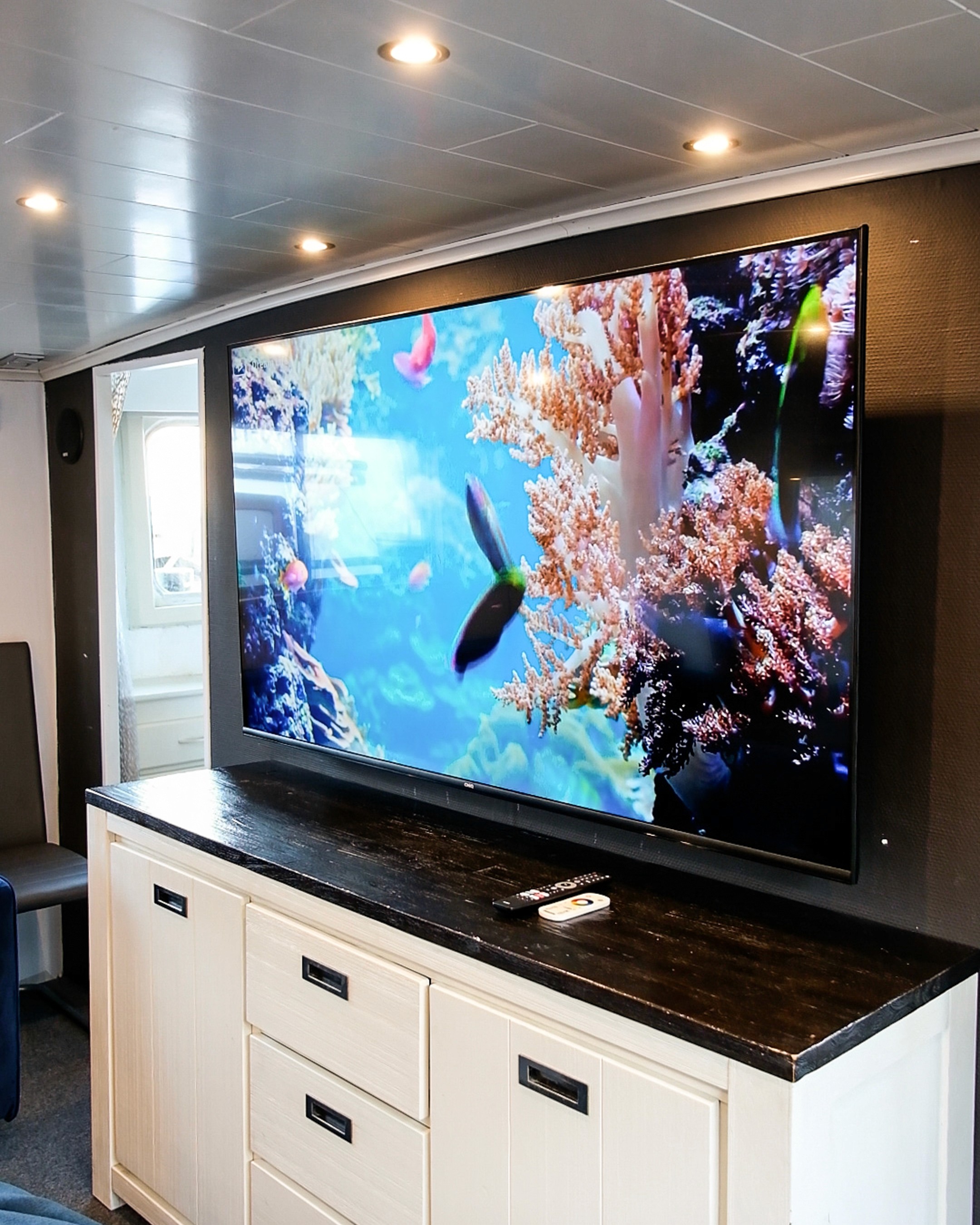 Grey marble bathroom with round mirror and floating sink