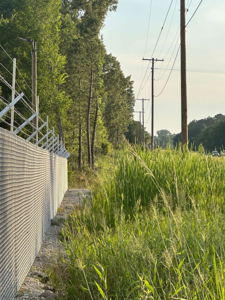 This picture shows a security fence with razor wire at the top that we can install around properties.  We also run security fencing from our welding and fabrication shop in Henderson, Texas.