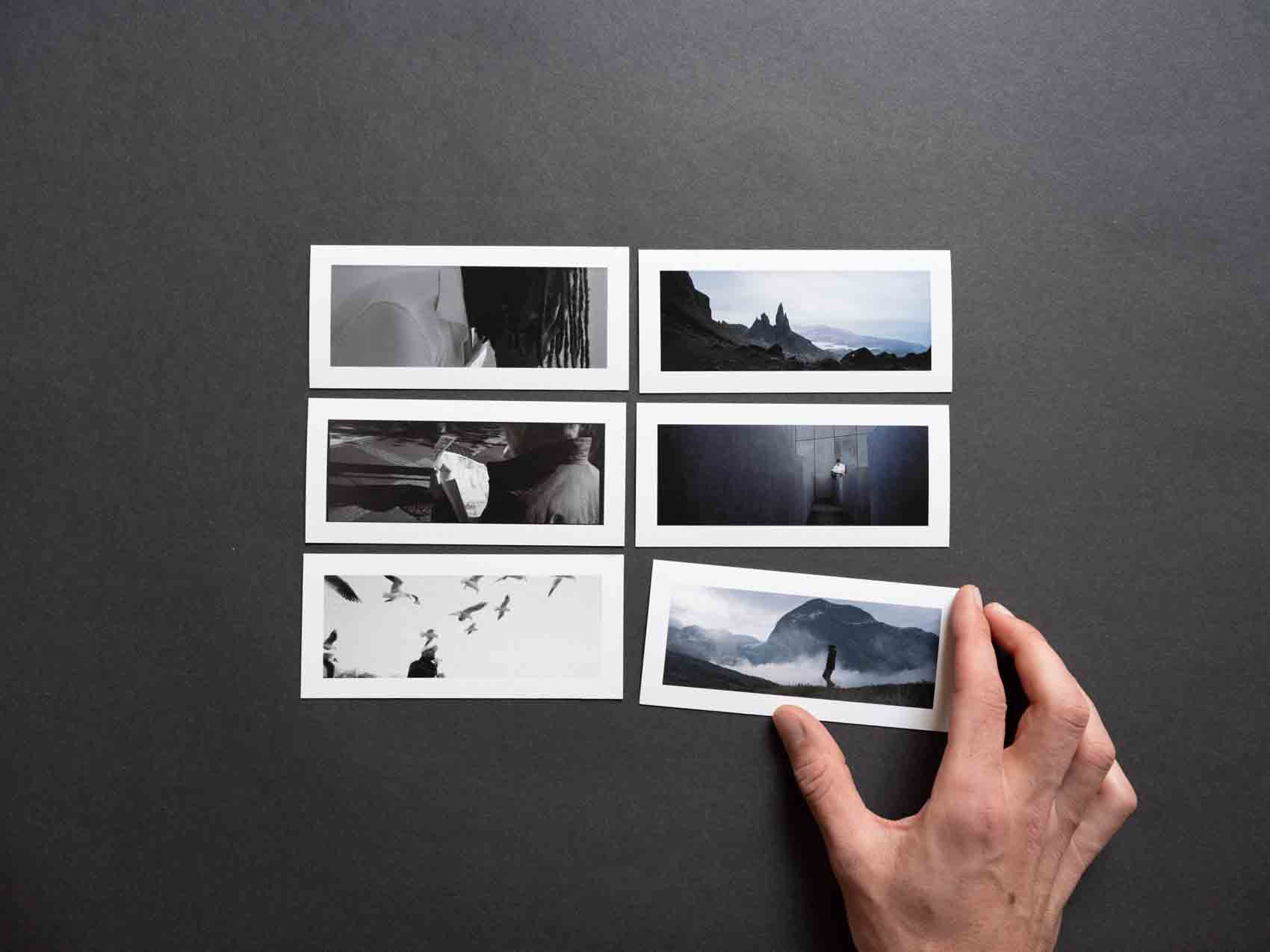 A photographer displaying a tiny panoramic photo print