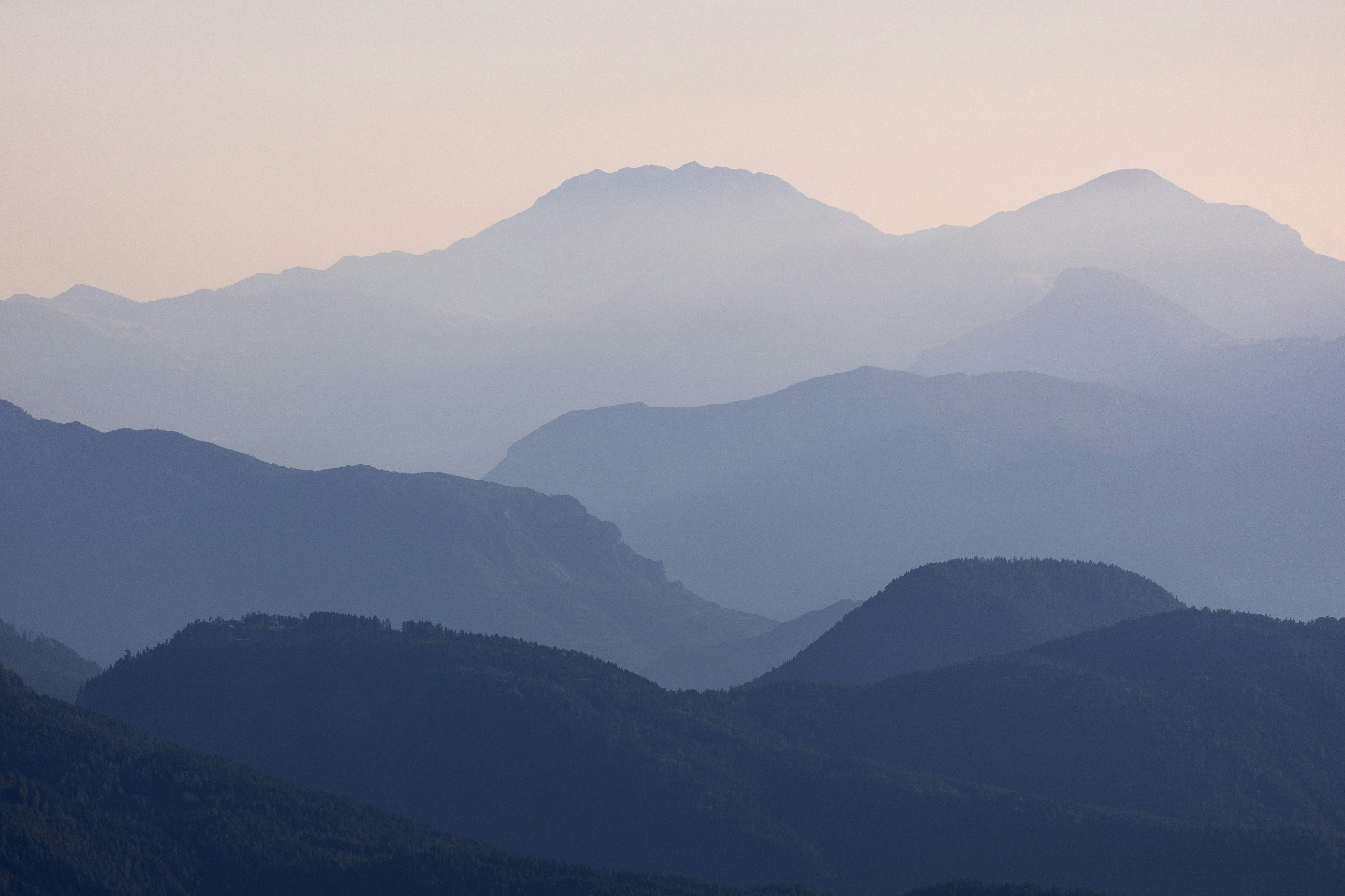 Layered blue mountain ranges fade into the sky.