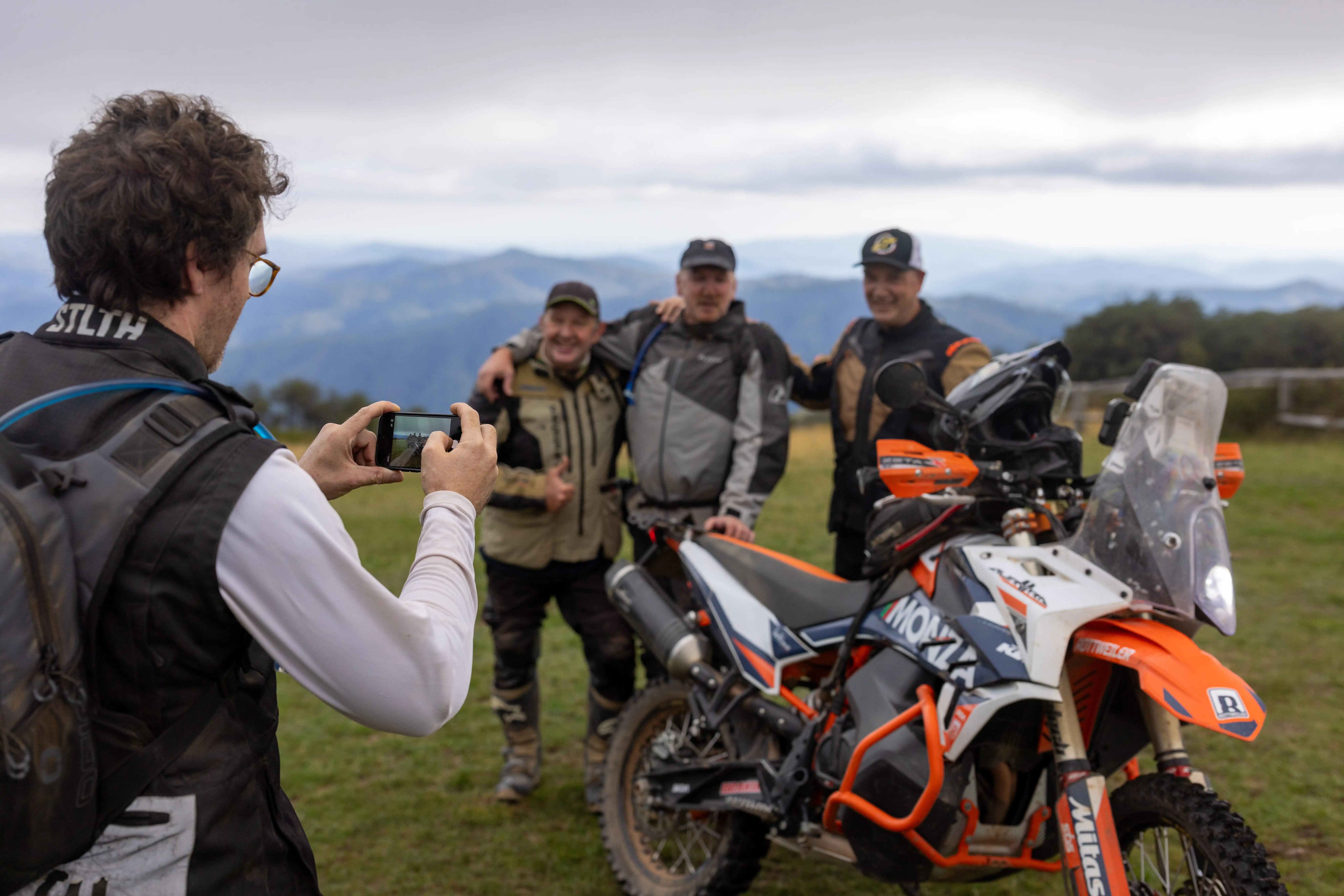 picture being taken in fornt of Craig's hut