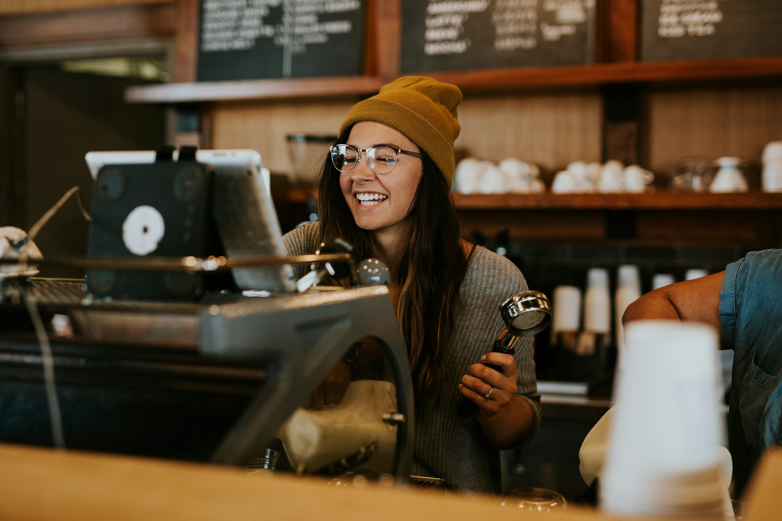 A woman behind a coffee counter