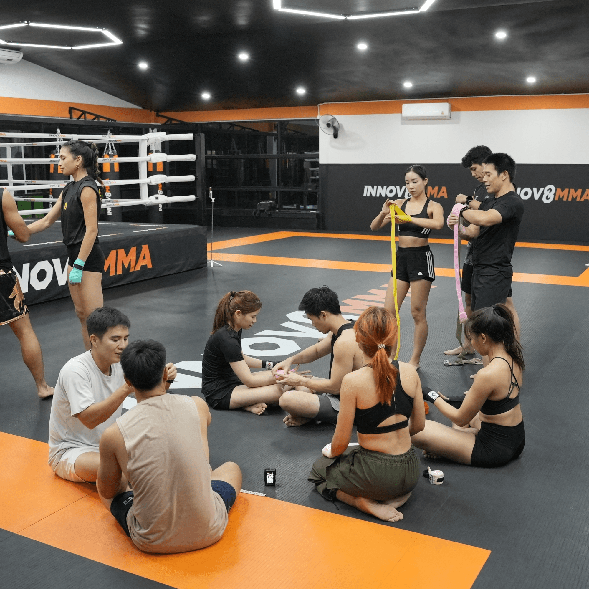 A female getting her hands wrapped for a muay thai class
