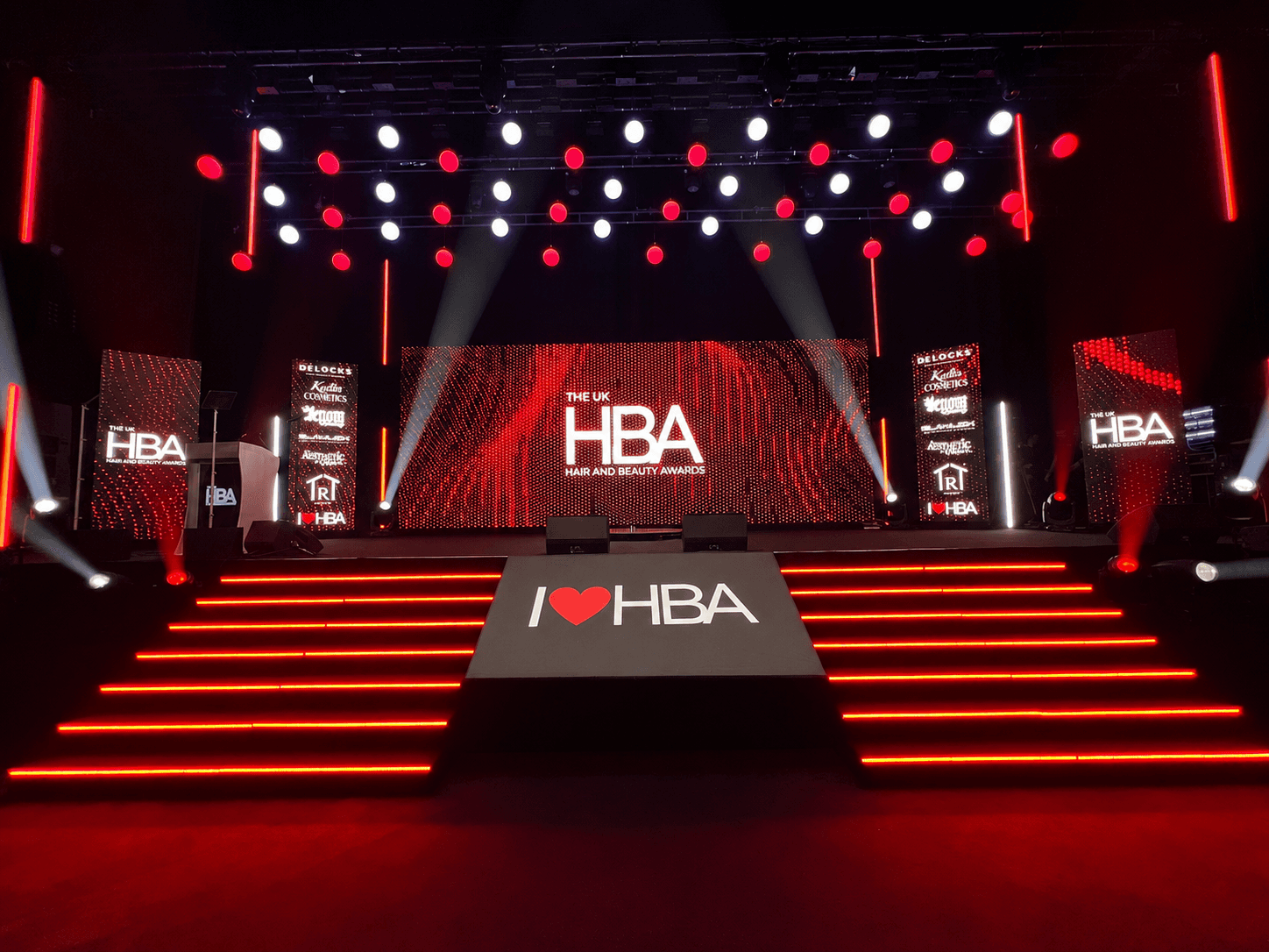 Stage Engage stage production for the UK Hair and Beauty Awards, featuring LED screens, illuminated steps and red event lighting.
