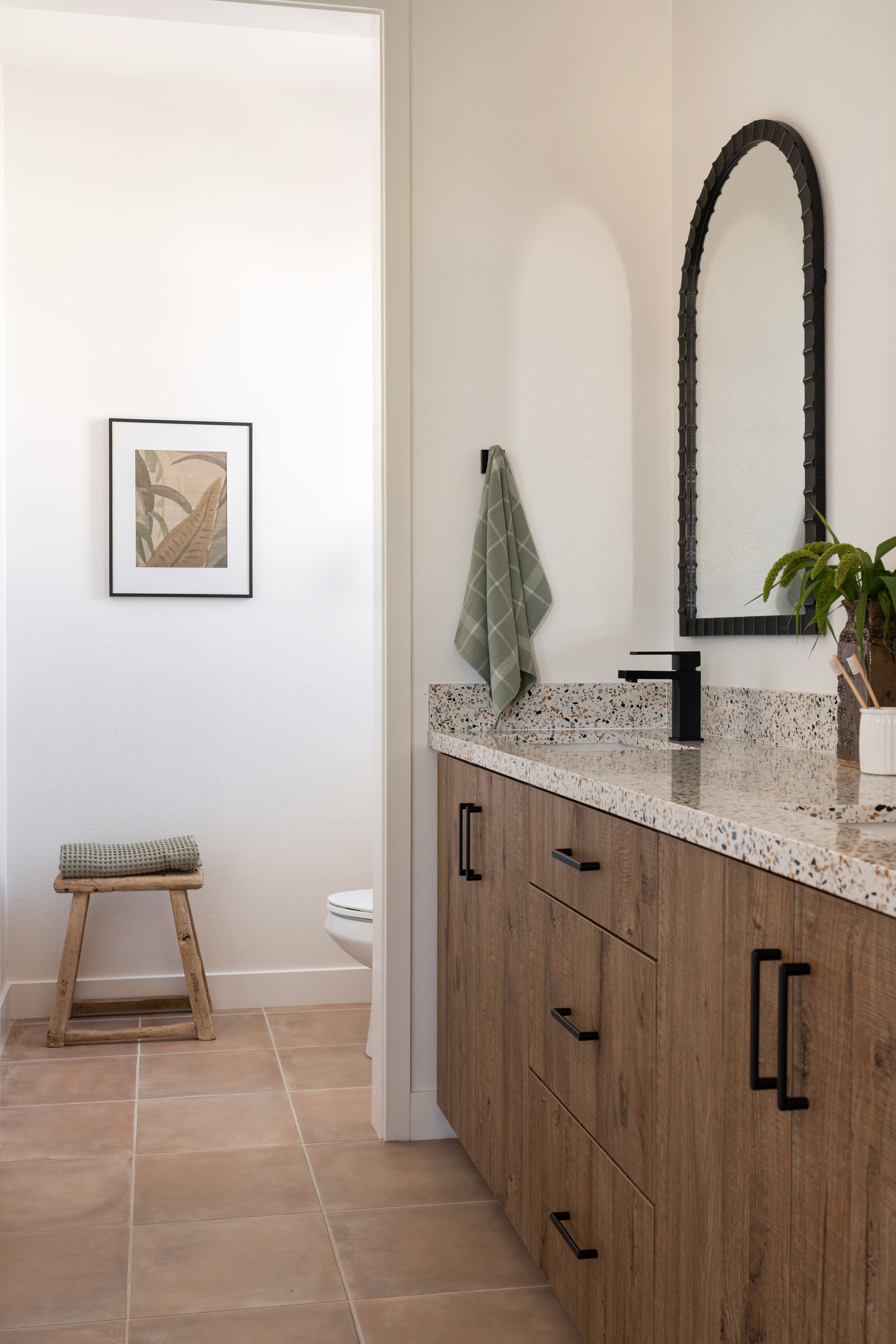 Primary bathroom view of sinks, toilet and shower area