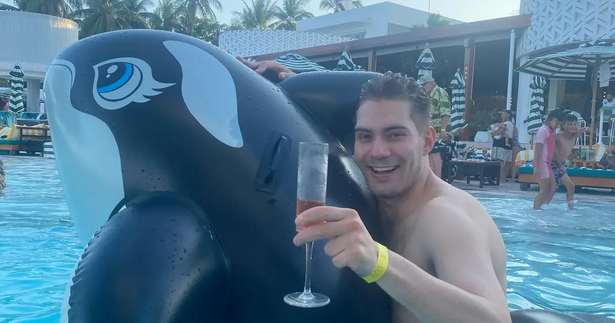Enzo, the digital nomad, parties in a swimming pool on a blow-up orca