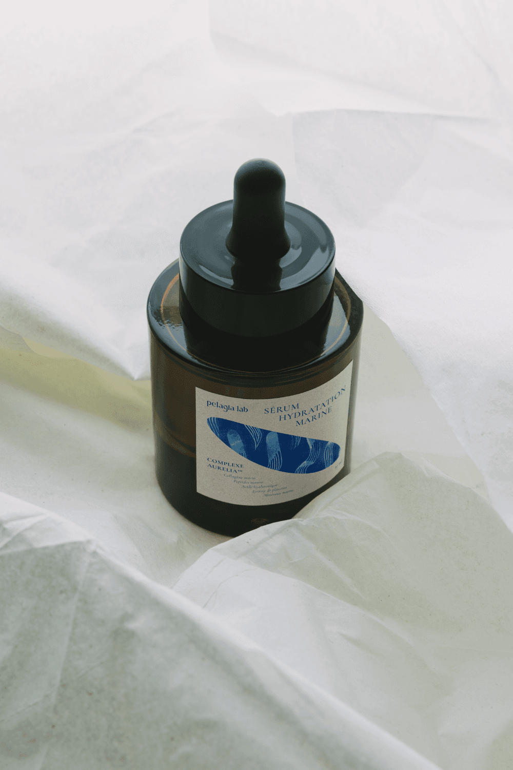 Young man in a formal outfit with a striped shirt, grey tie, and black coat. The tone is serious and professional, emphasizing subdued elegance.