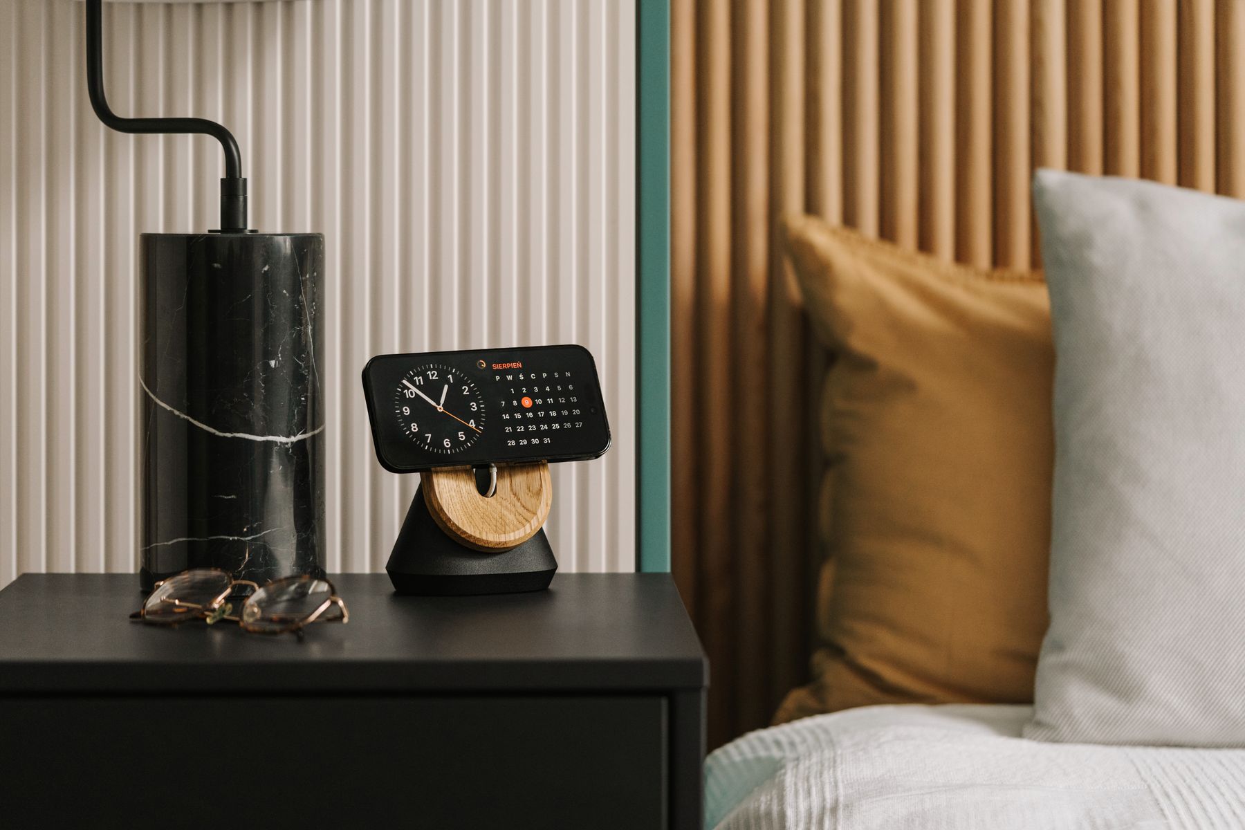 Smartphone clock displayed on a modern bedside table