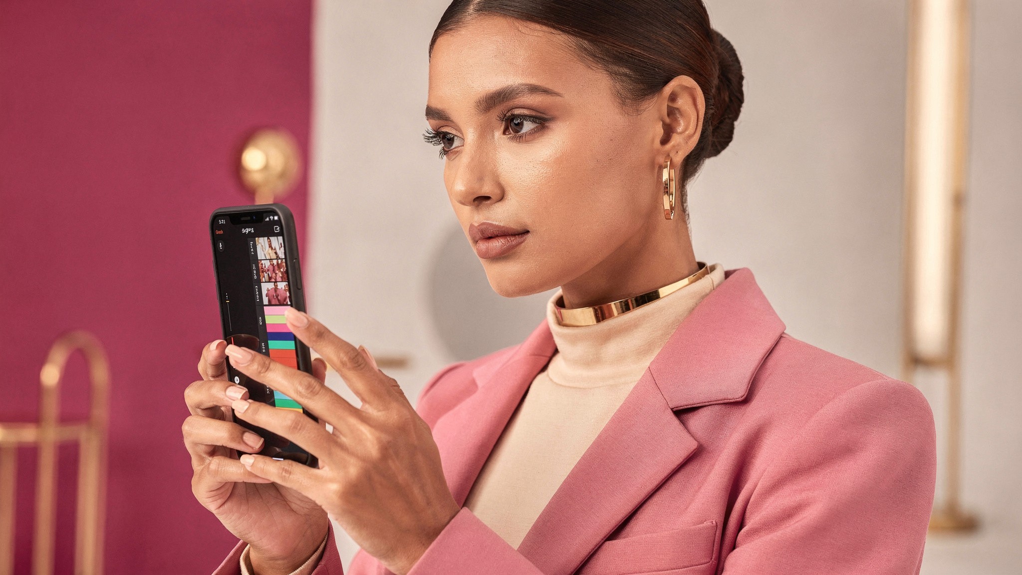 Adult woman creator looking at a vertical video timeline on her phone screen