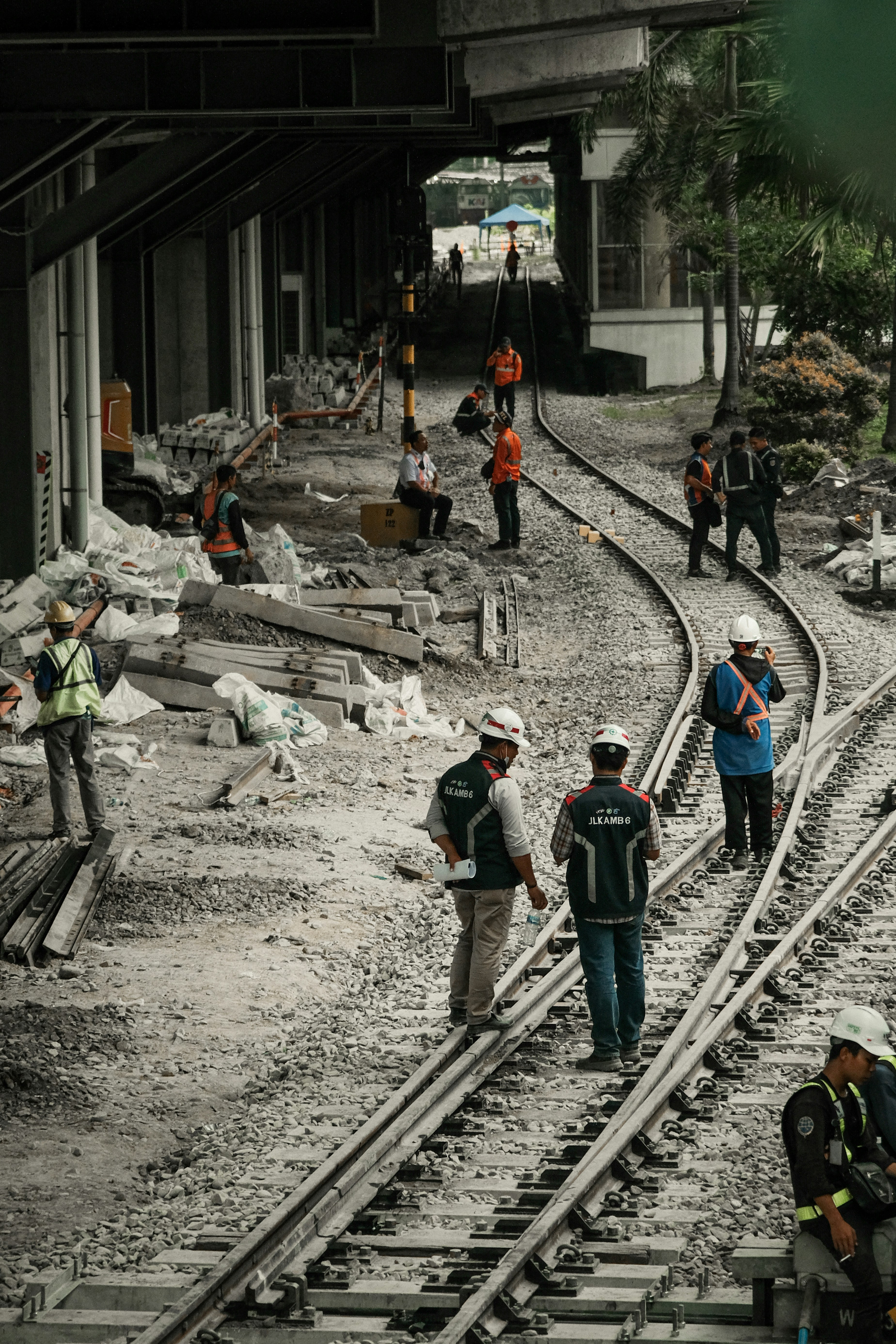 a group of people standing on top of train tracks