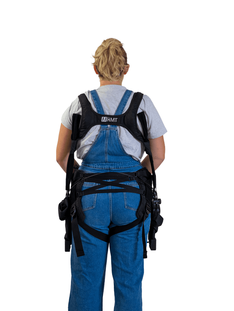 Rear view of a person wearing the Wave exoskeleton, designed to support the back during the lifting of repetitive and heavy loads.