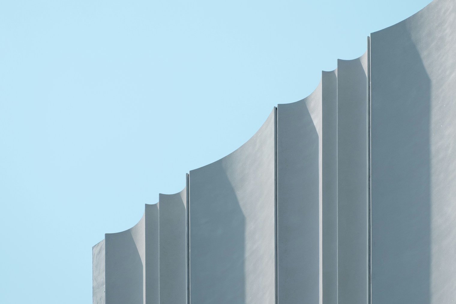 Minimal concrete architecture against a pale blue sky
