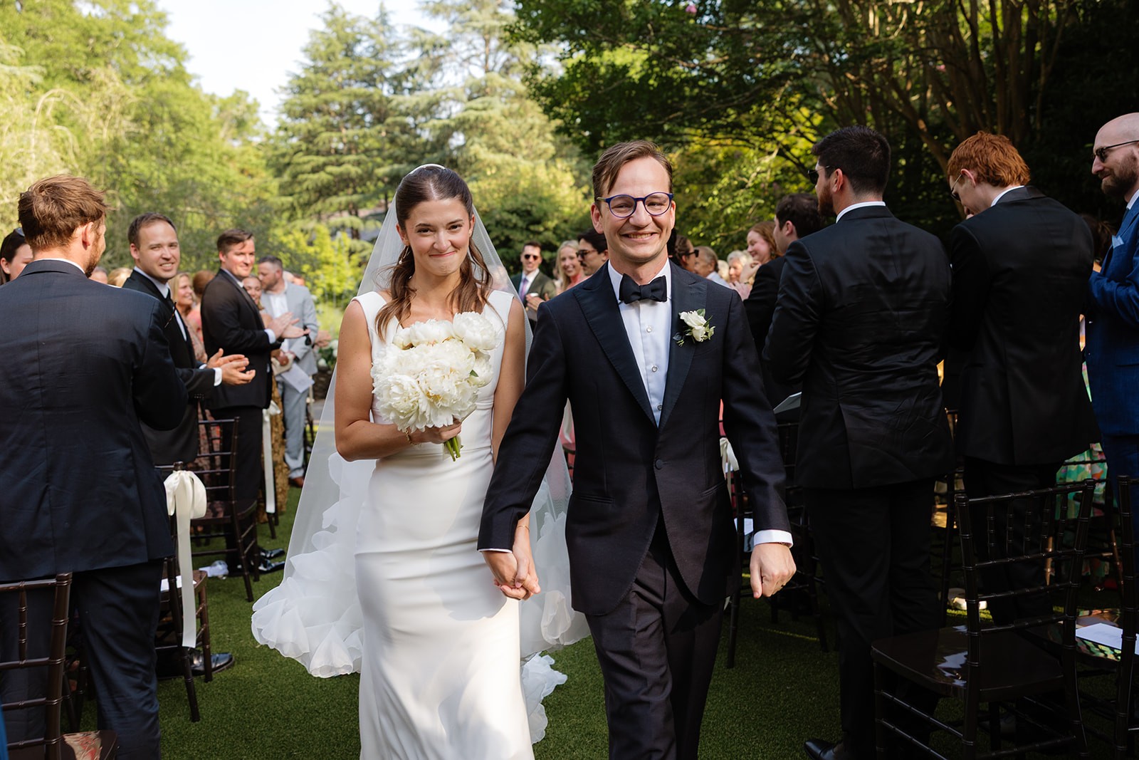 Paige and Hajo walking down the aisle after their ceremony at Shallow Gardens.