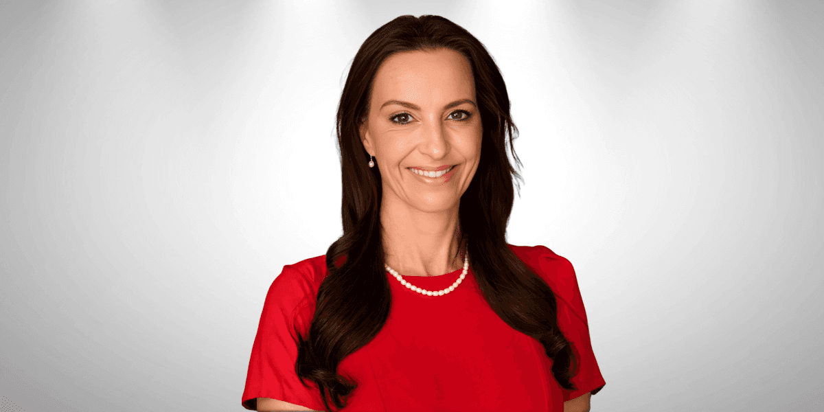 Lorna Greyling, a resilient woman in a red dress, embodying hope, joy, and strength in adversity.