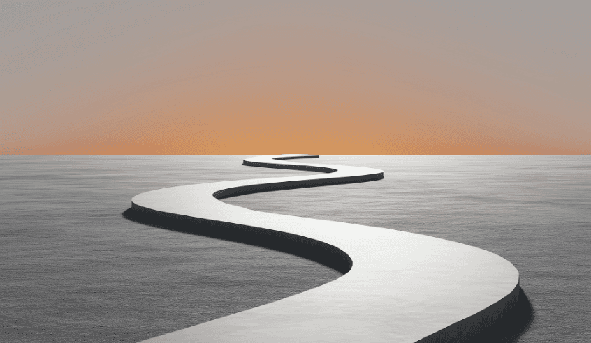 Two men discuss a project while standing at a laptop in an office.