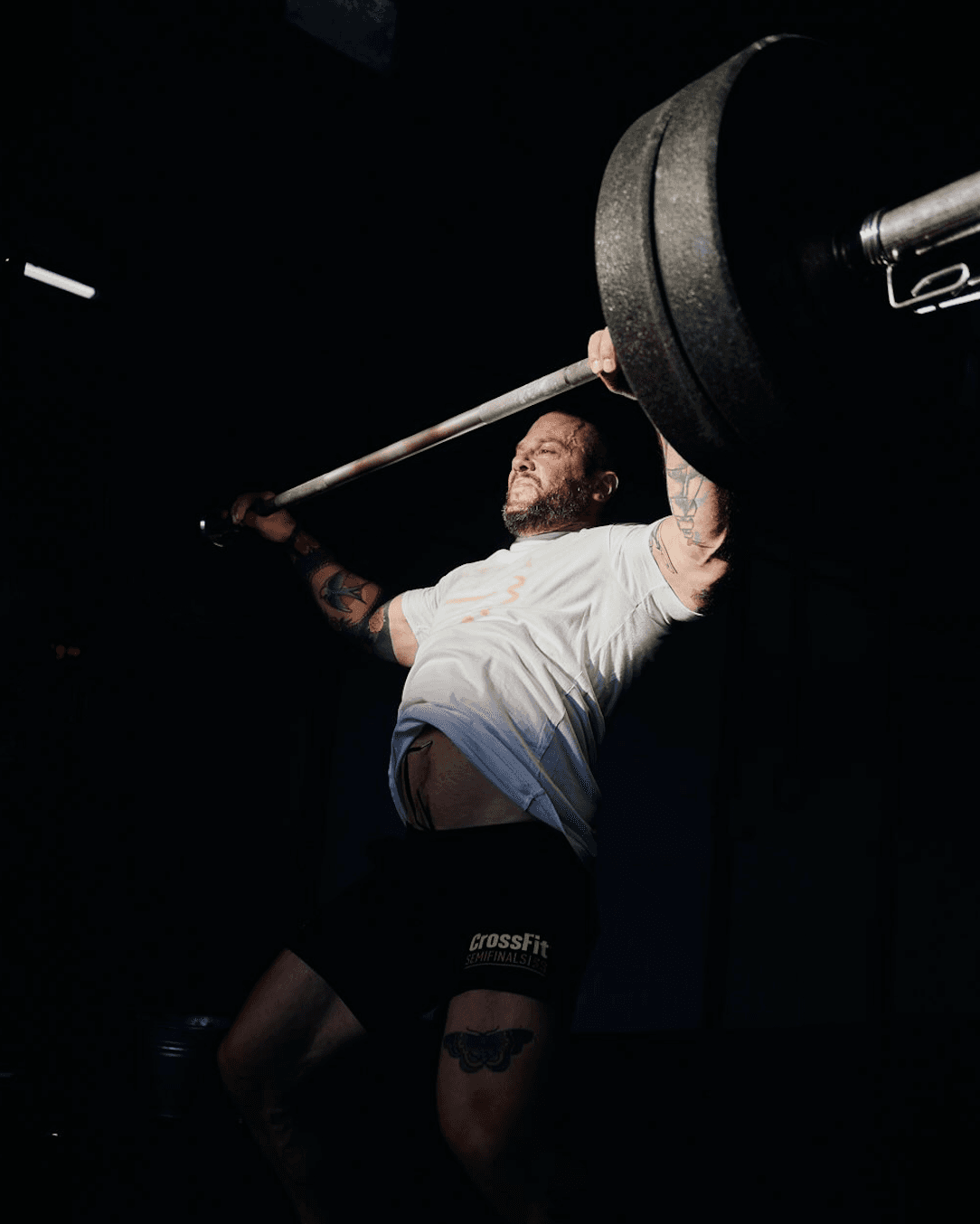 Rachel, personal trainer, looking to the side confidently in a fitness studio